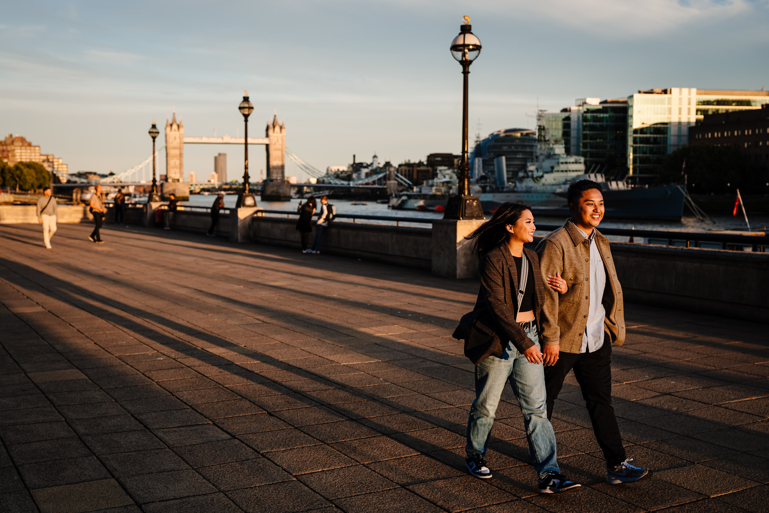 Couple walking together Tower Bridge Behind them