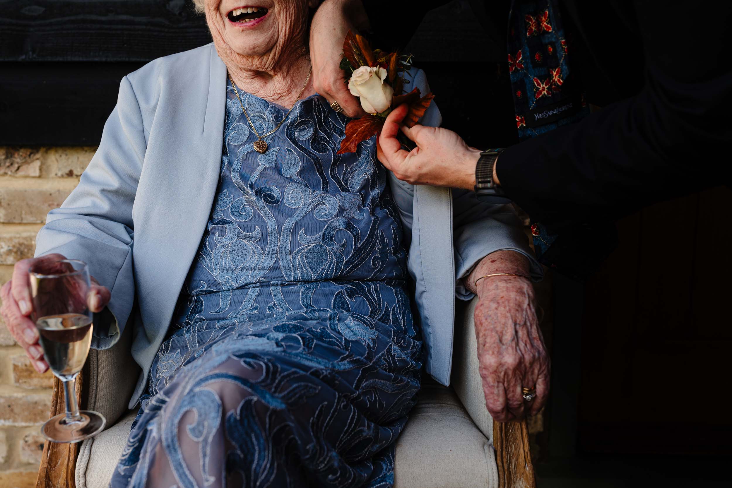 nan having her flower fixed by grandson