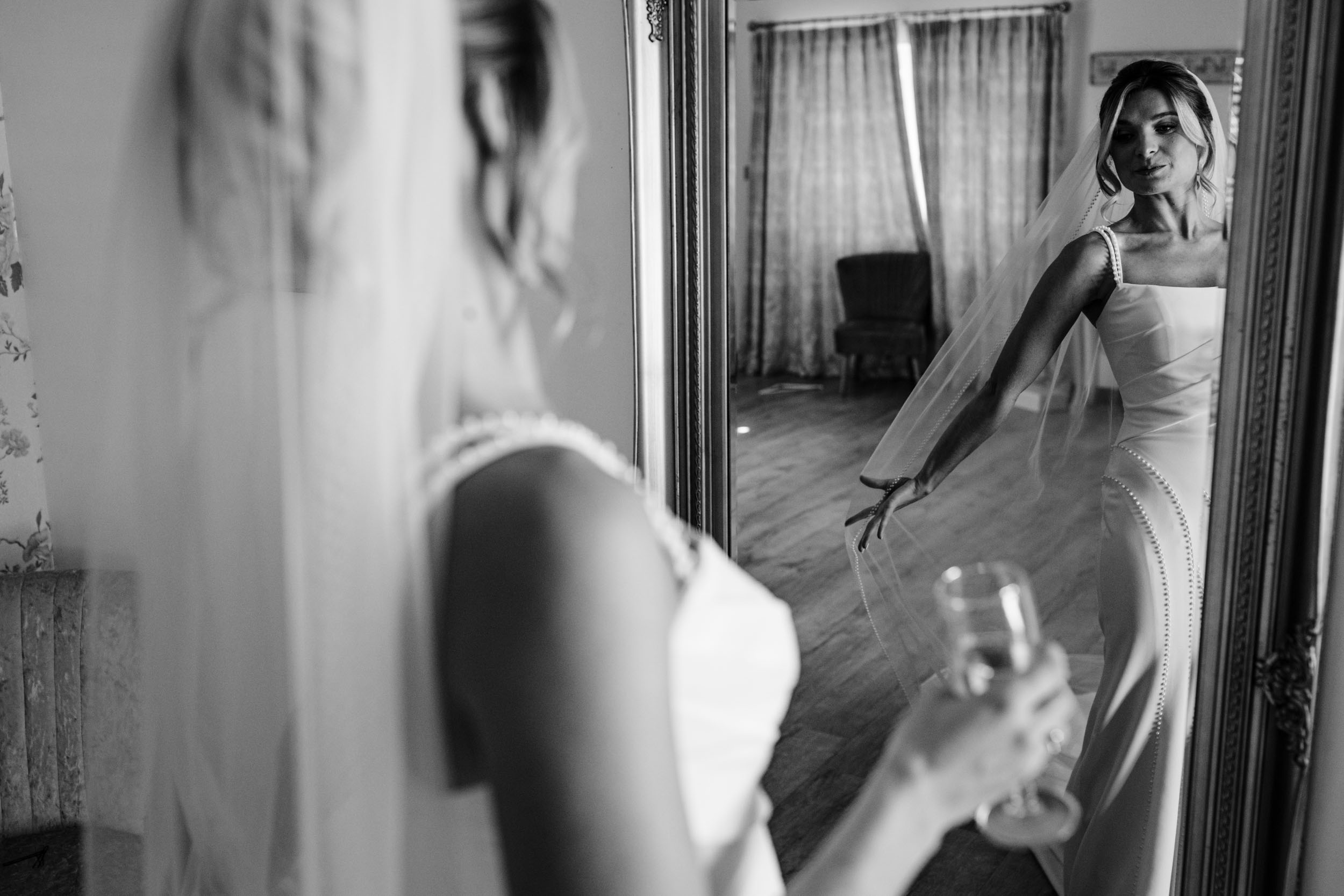 bride looking at herself in the mirror