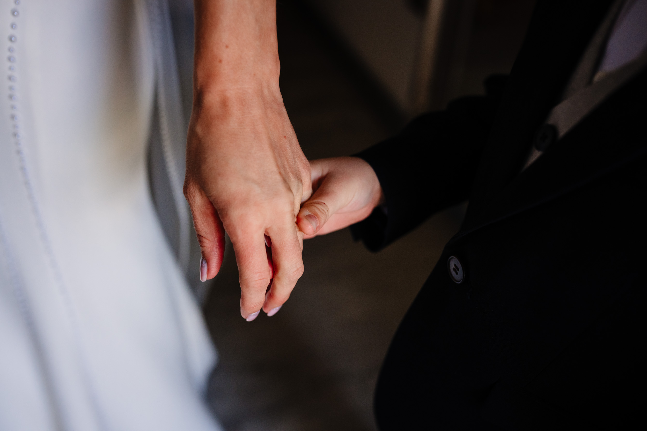 bride and son holding hands