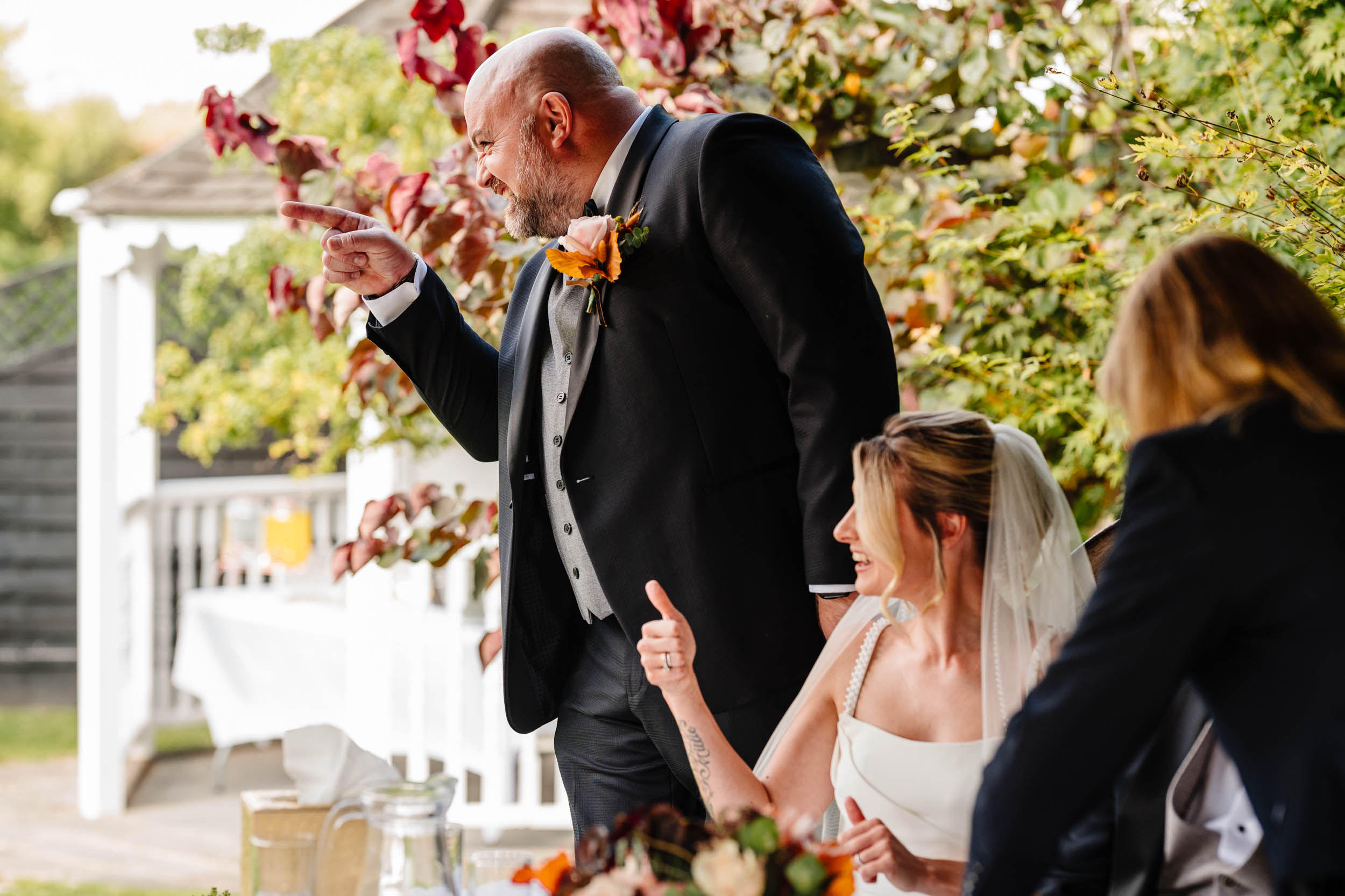 groom having fun pointing finger at guests