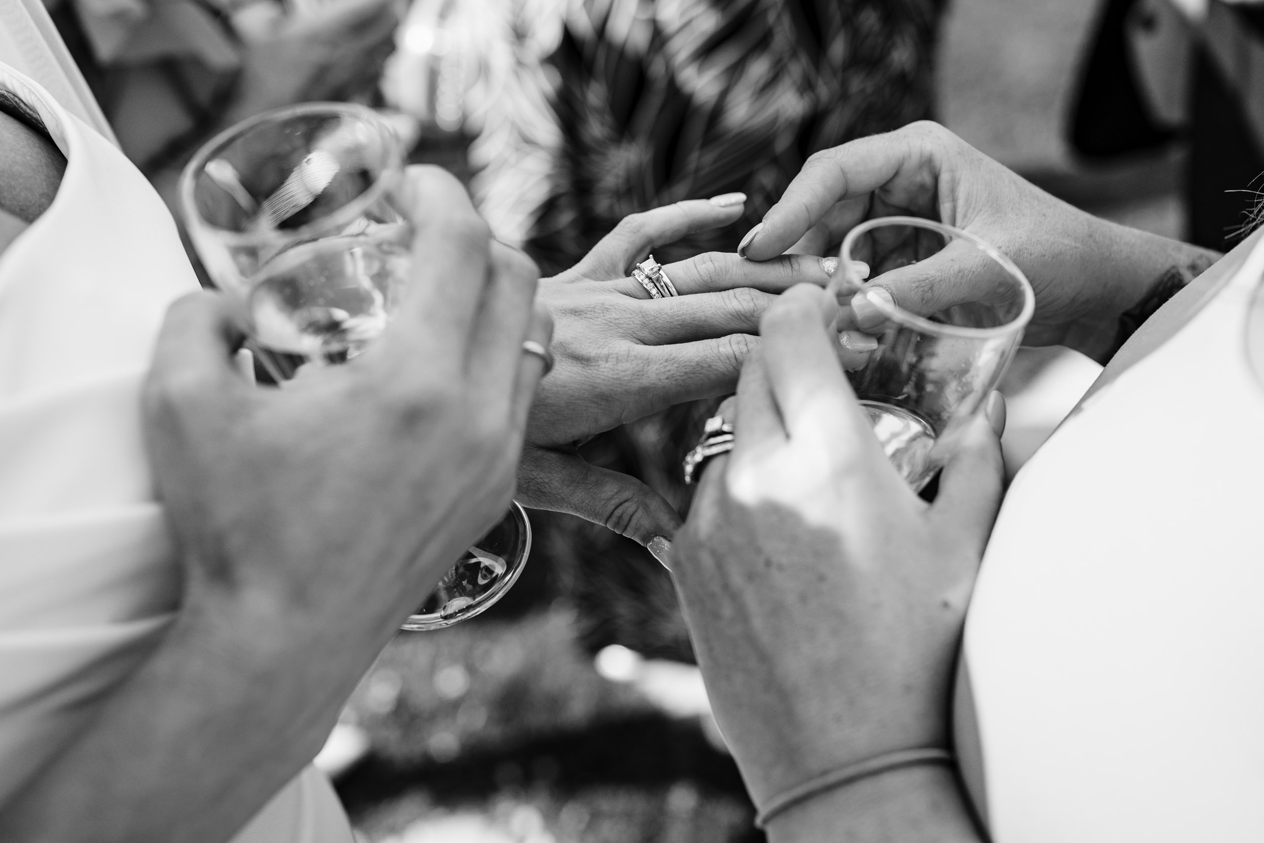 friend looking at bride's rings