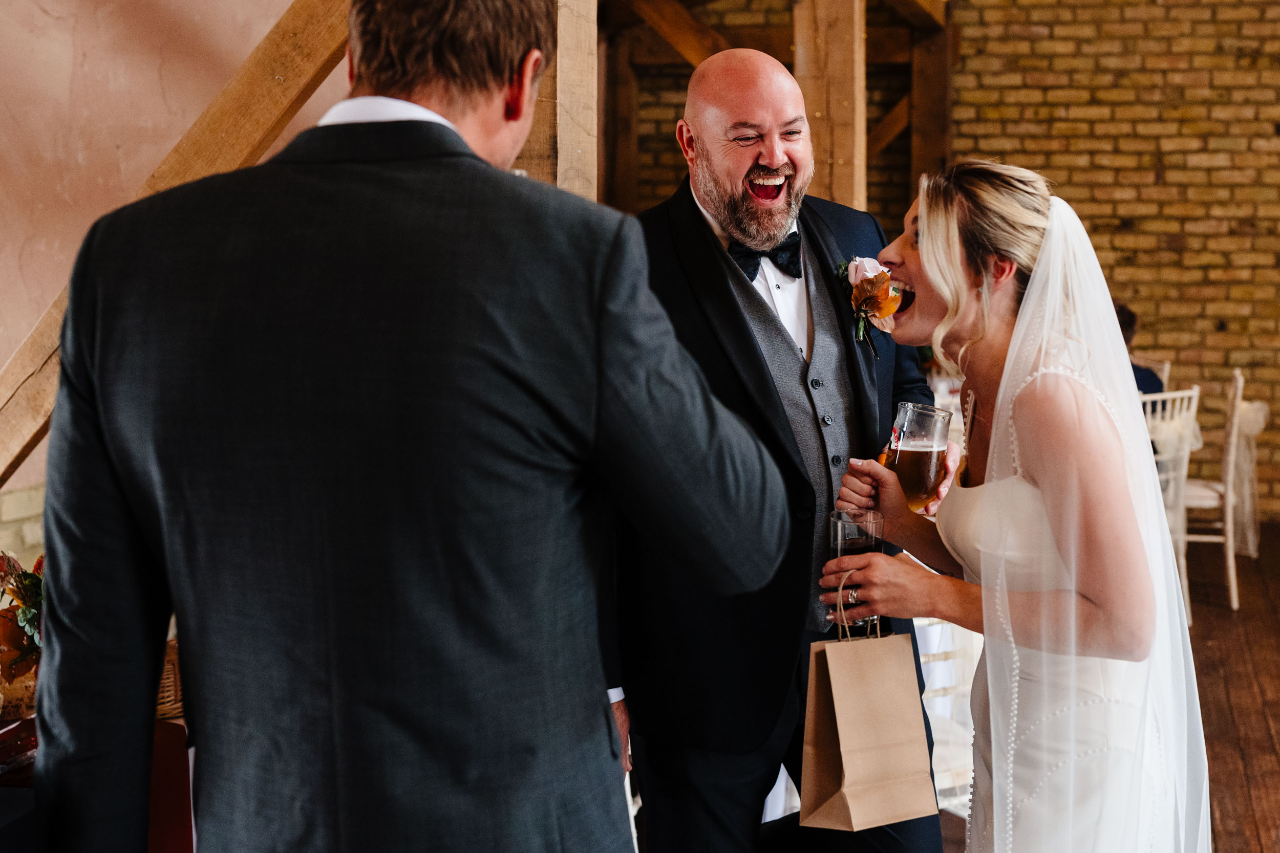 bride and groom laughing with guests