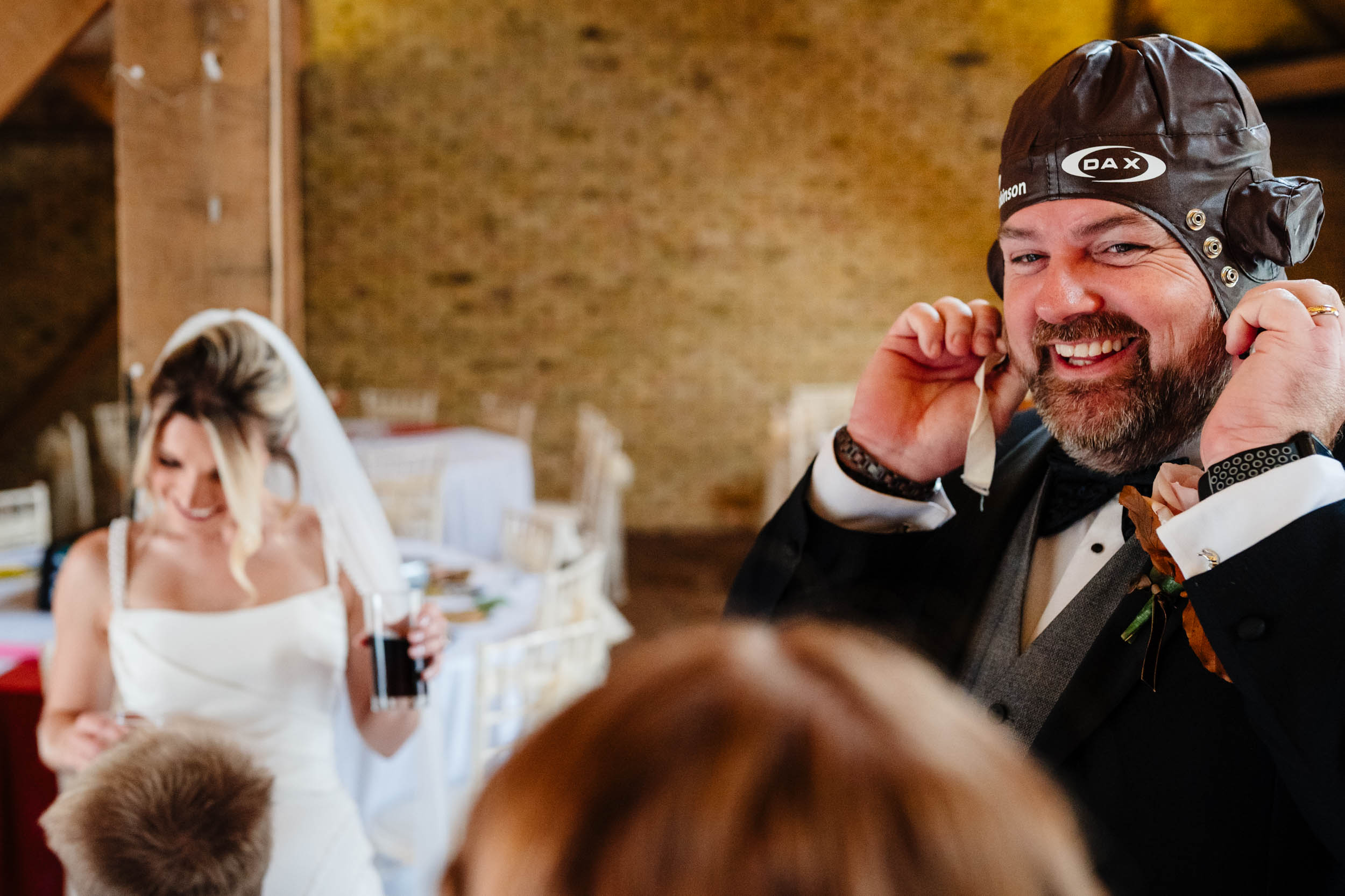 groom trying a hat on