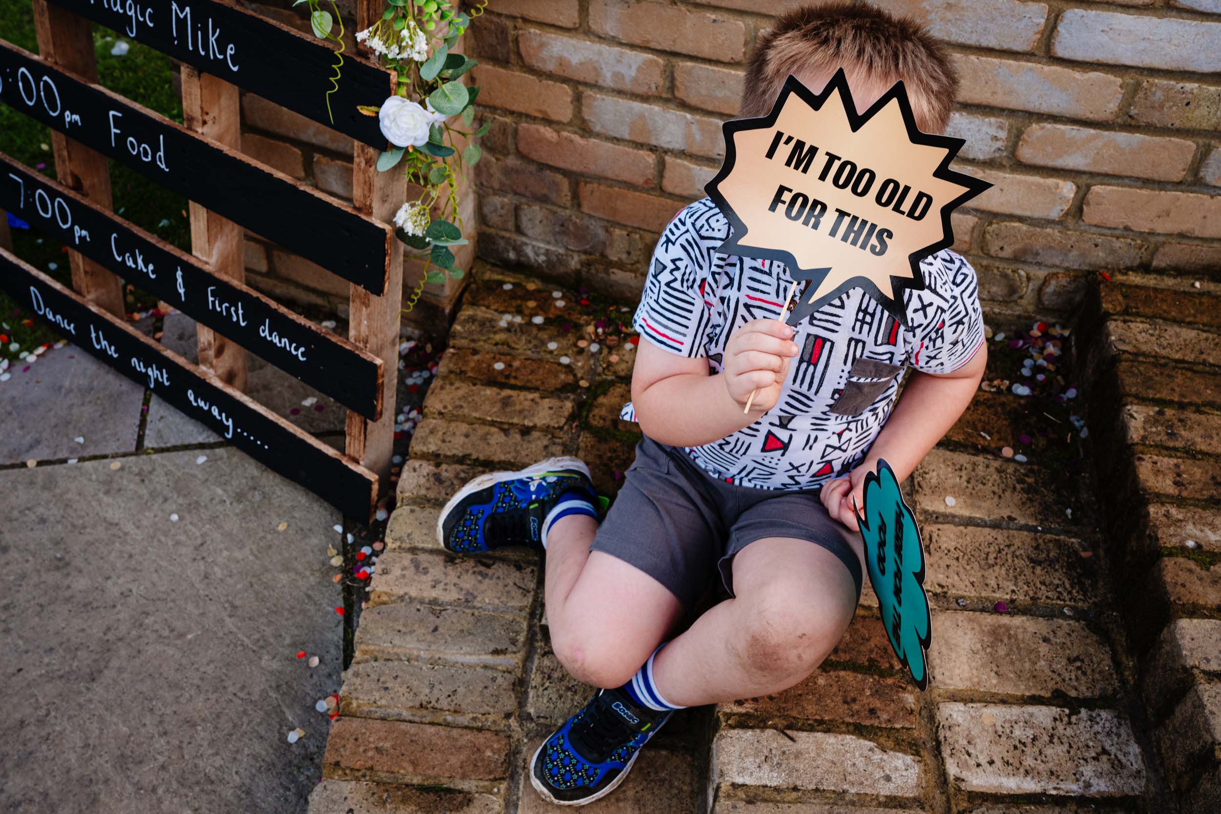 kid holding a im too old for this sign