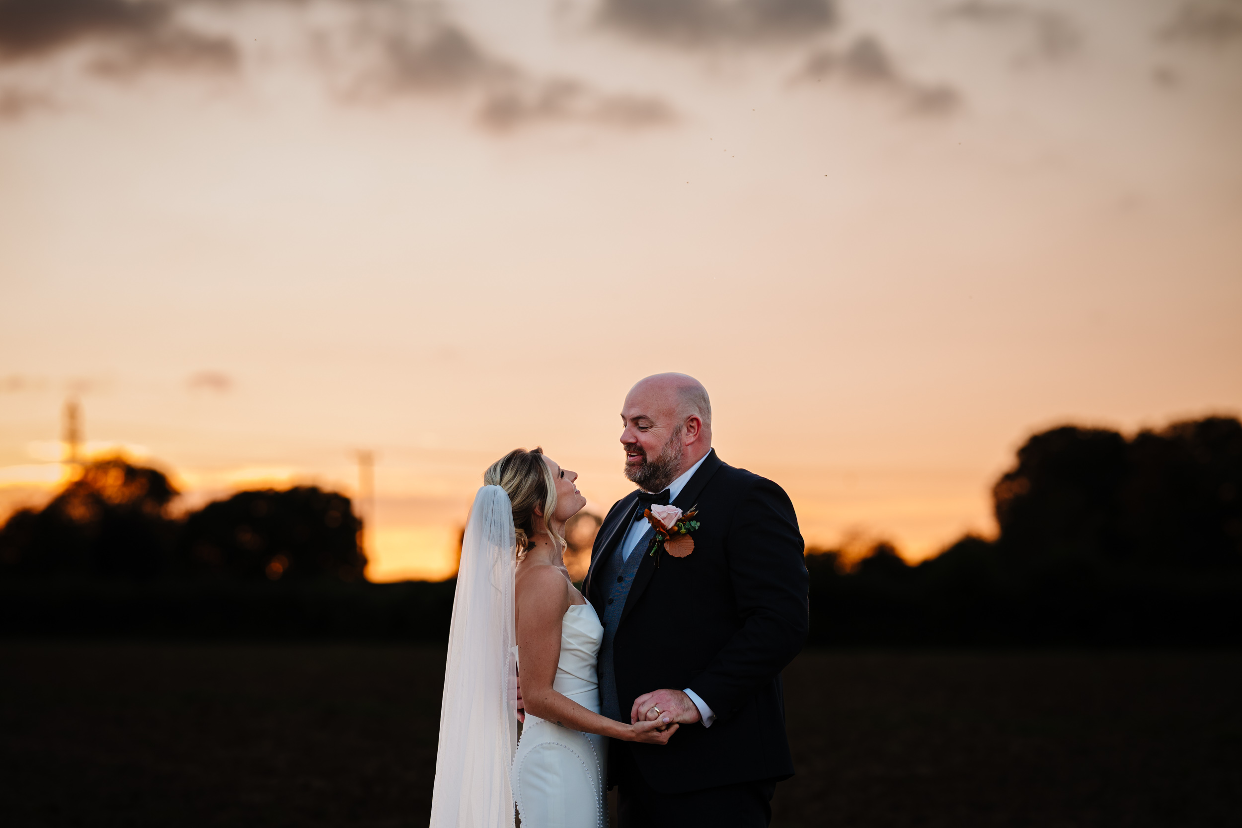 bride and groom in a field