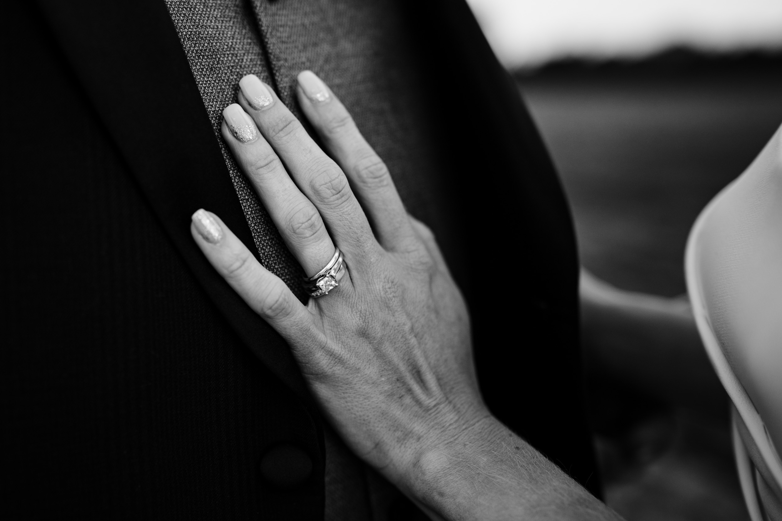bride's hand on groom's chest