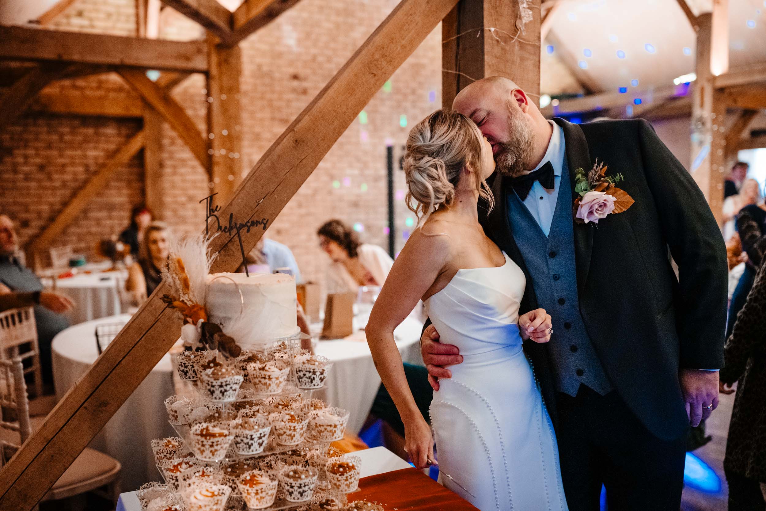 bride and groom kissing after cake cutting