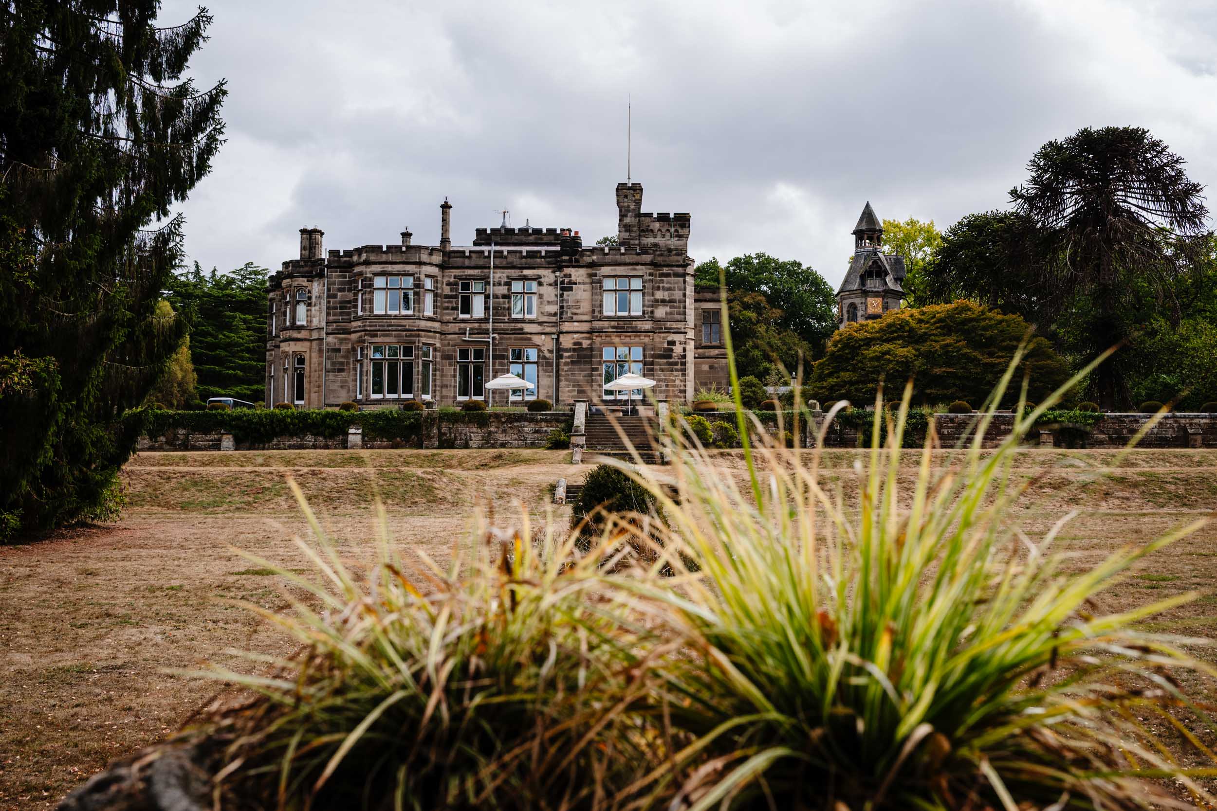 Wide shot of Hampton Manor from a distance surrounded by greenery