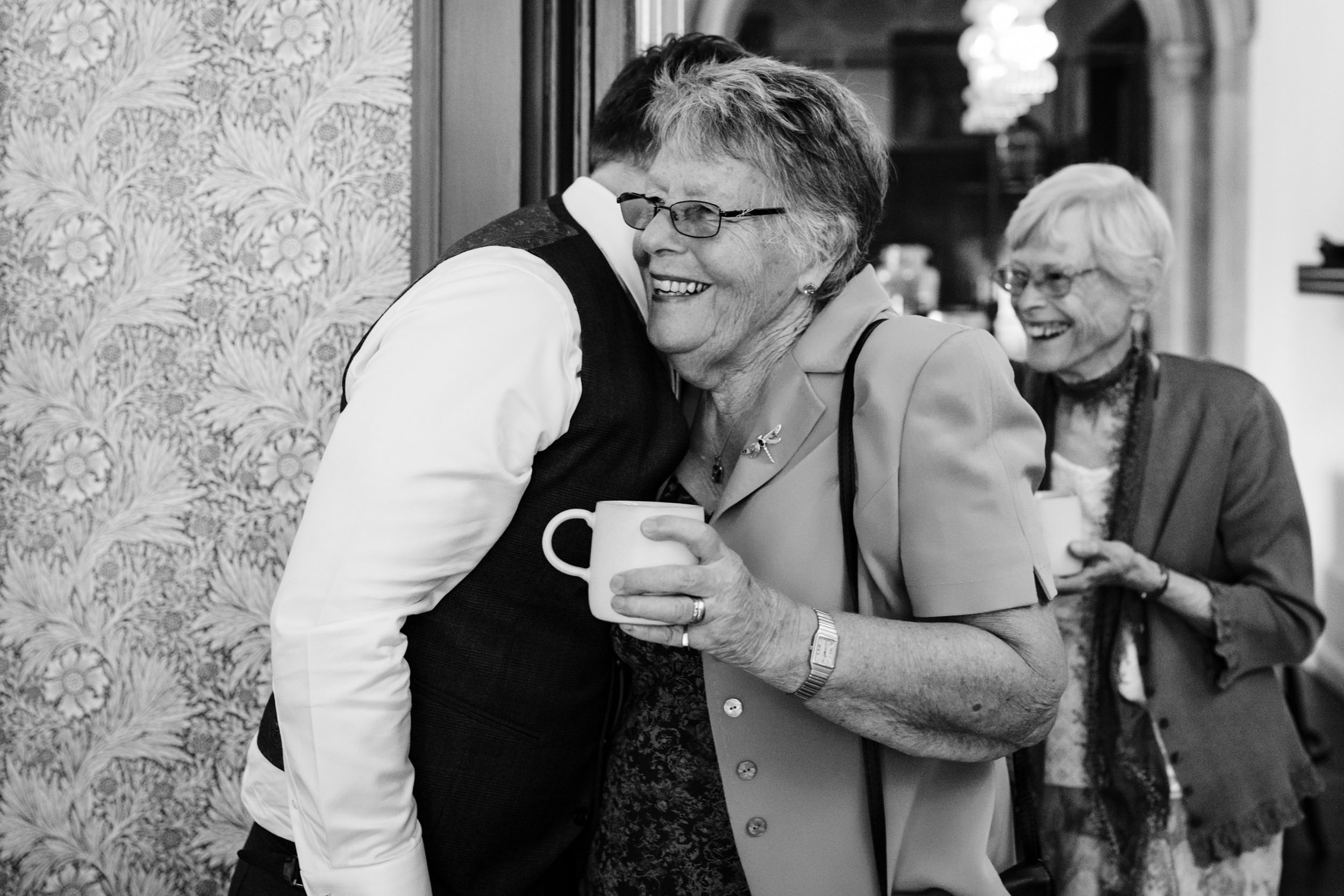 Sam greeting an elderly relative inside the manor