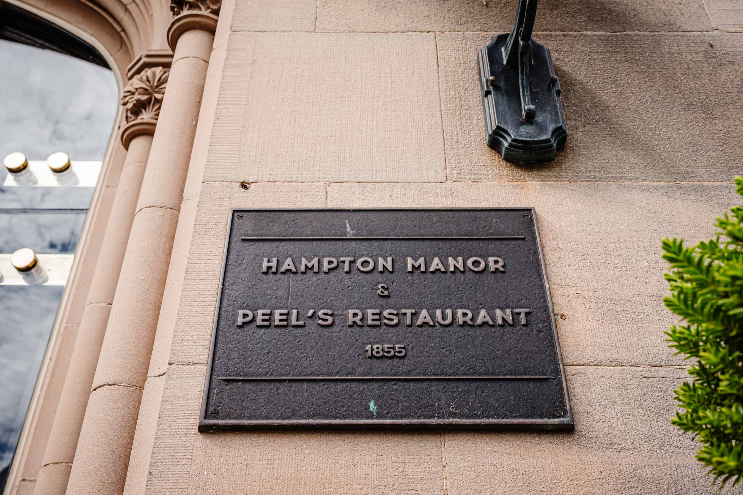 Sign outside Hampton Manor pointing to Peel’s Restaurant and hotel entrance