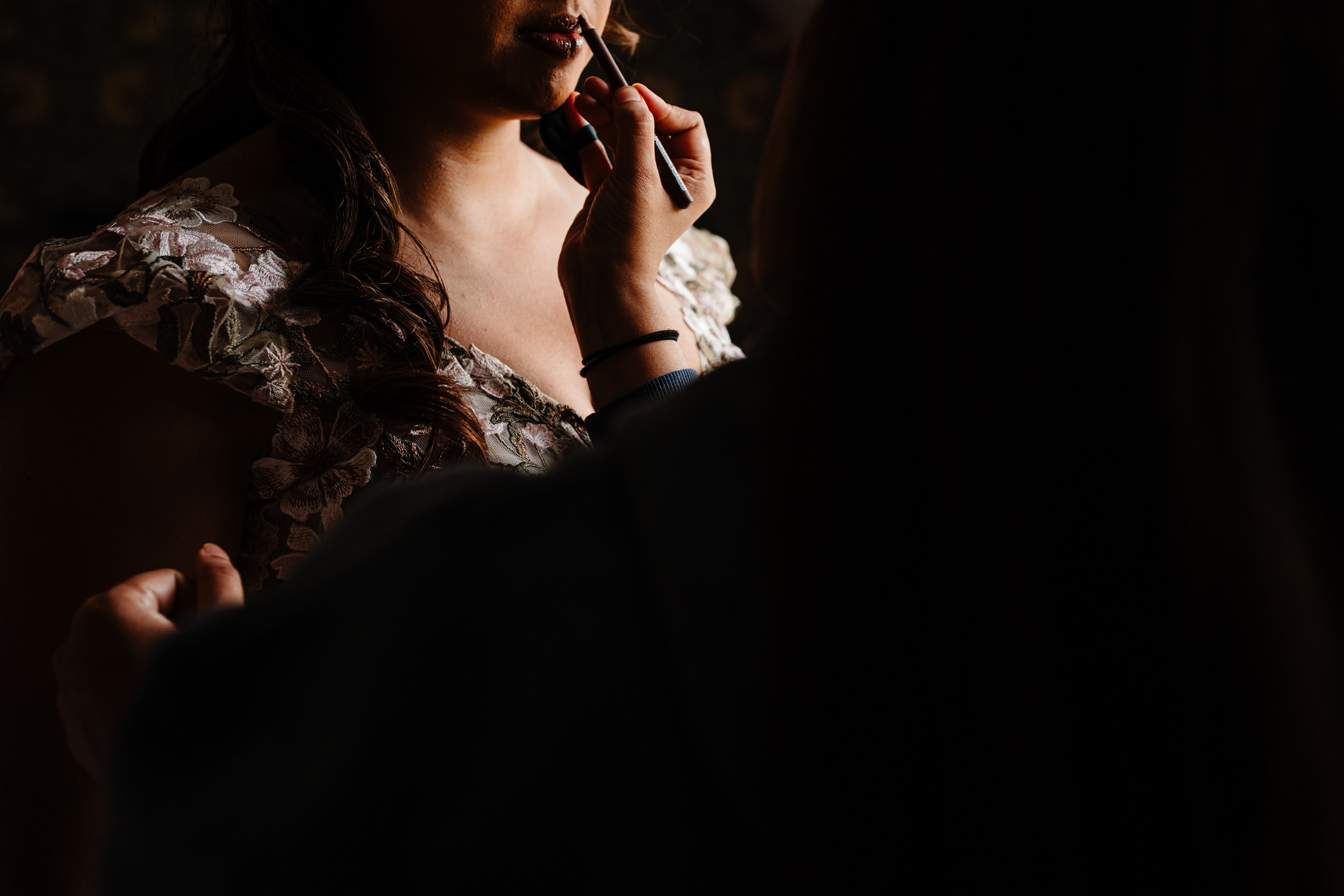 Bride having final lipstick touch ups before leaving for the ceremony
