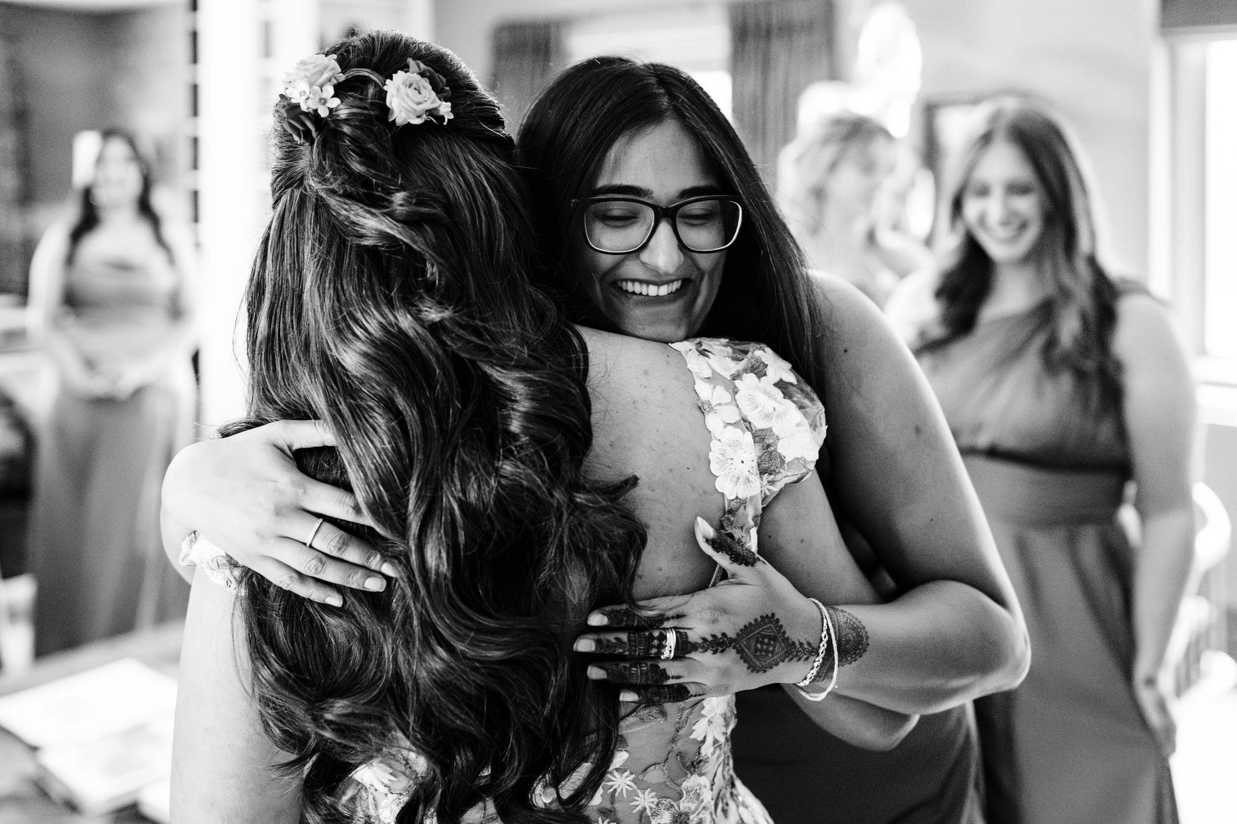 Embrace between Anika and her bridesmaid just before the ceremony