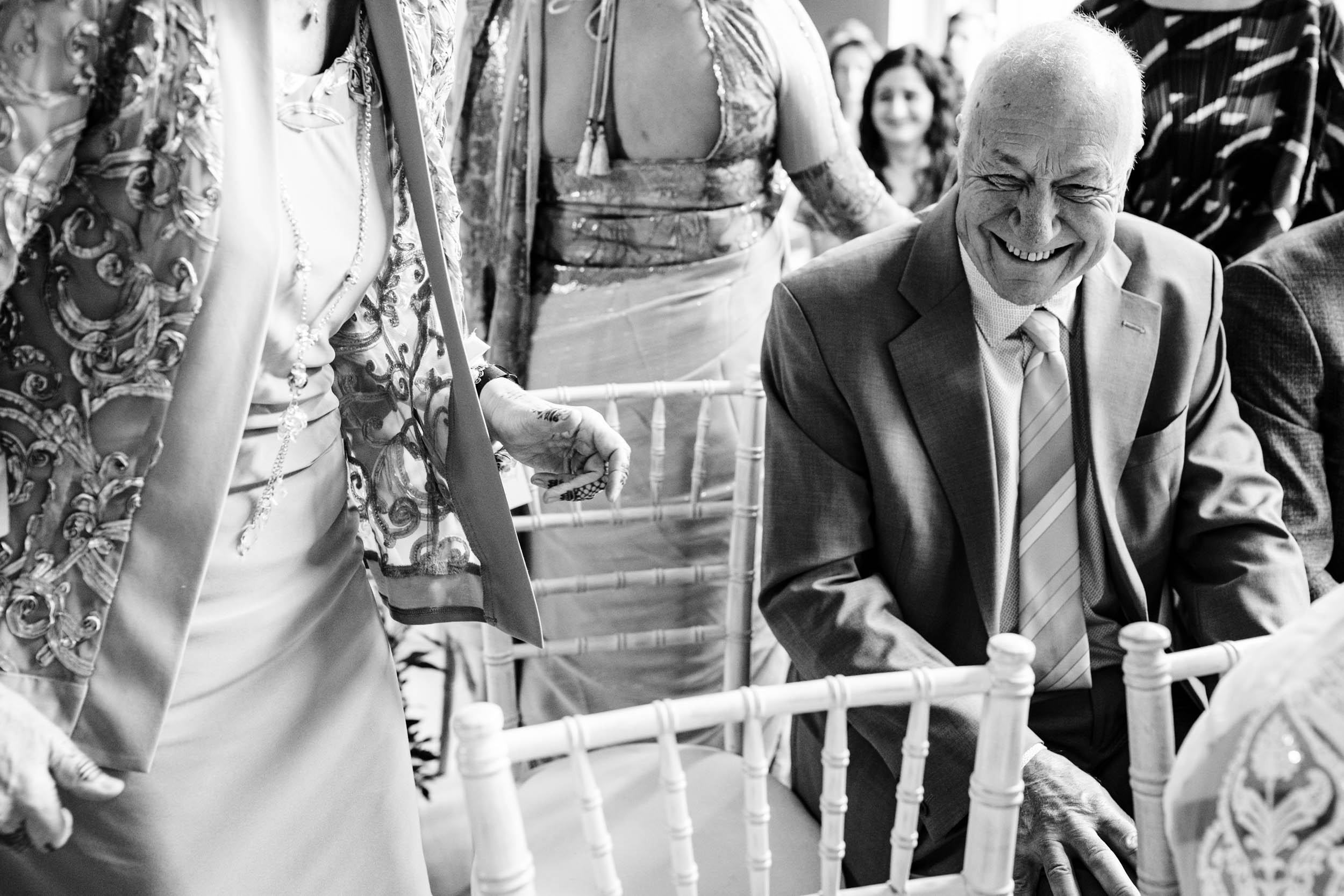 Guest laughing in the ceremony room moments before the aisle walk