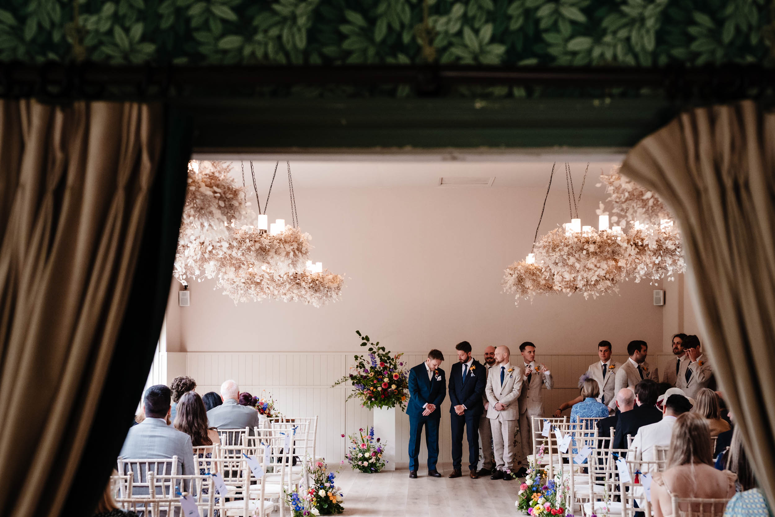 Groom and groomsmen waiting nervously for the bridal party to arrive