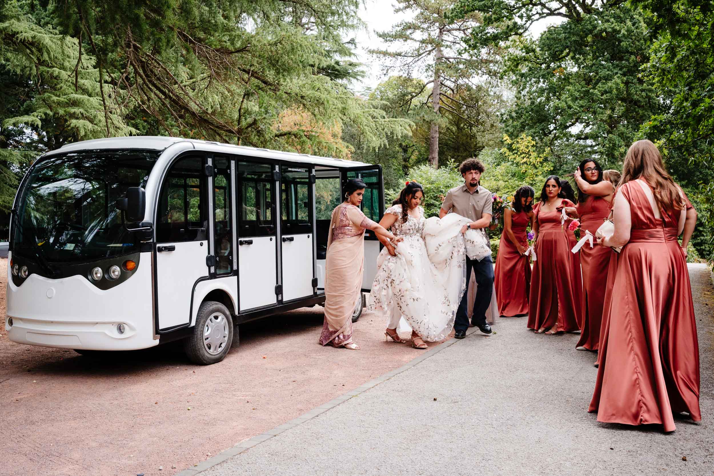 Bridal party including Anika and bridesmaids arriving at the manor on the transport bus