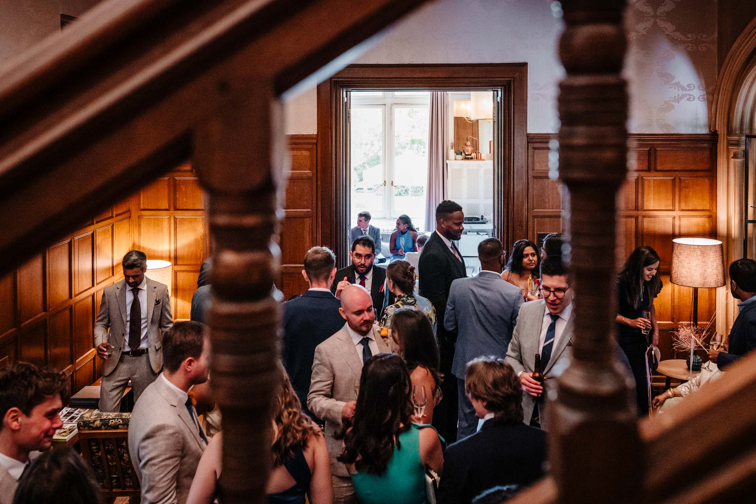 Reception crowd seen from the staircase inside Hampton Manor