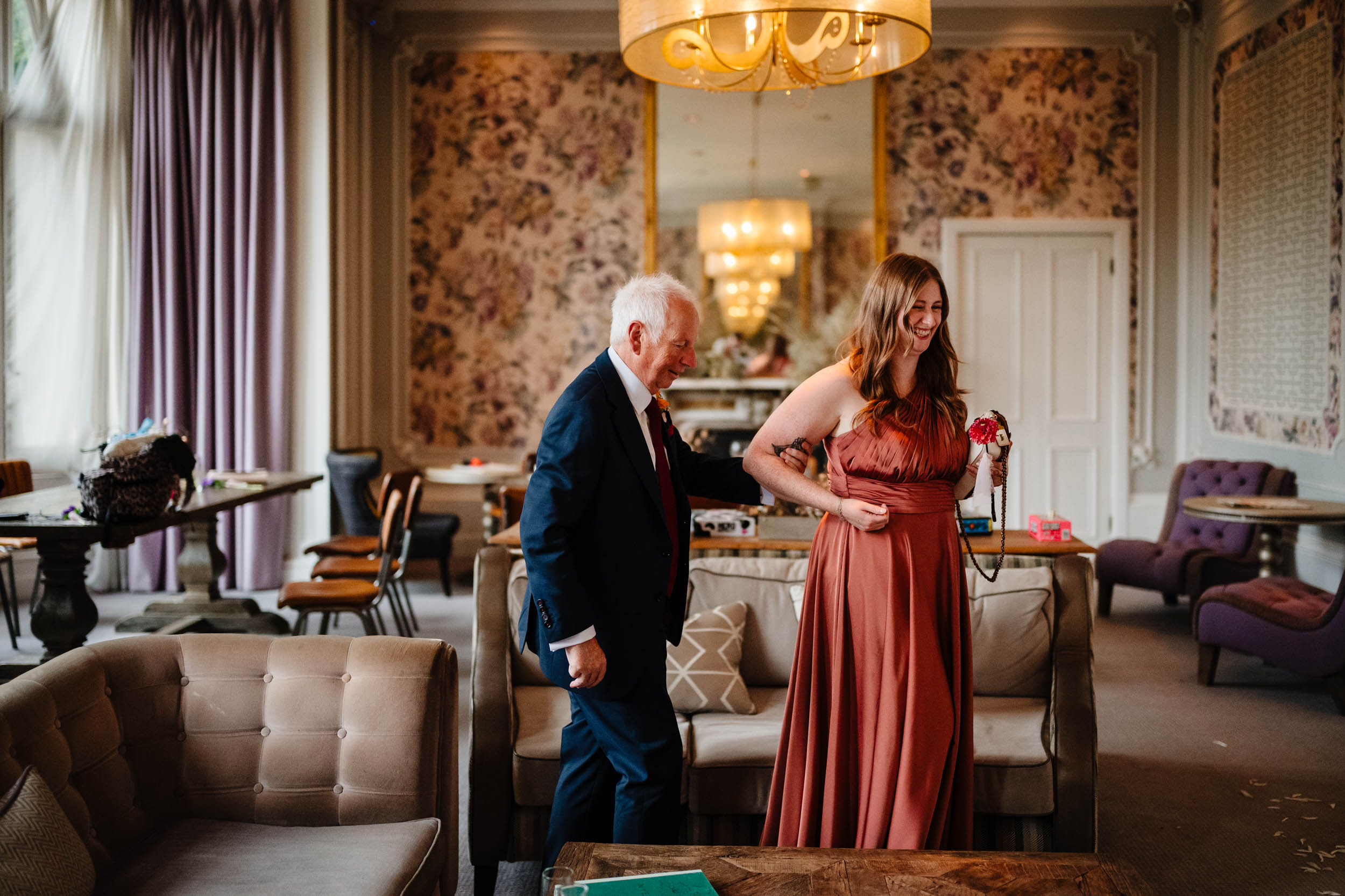 Bridesmaid helping Sam’s dad walk into the dining area