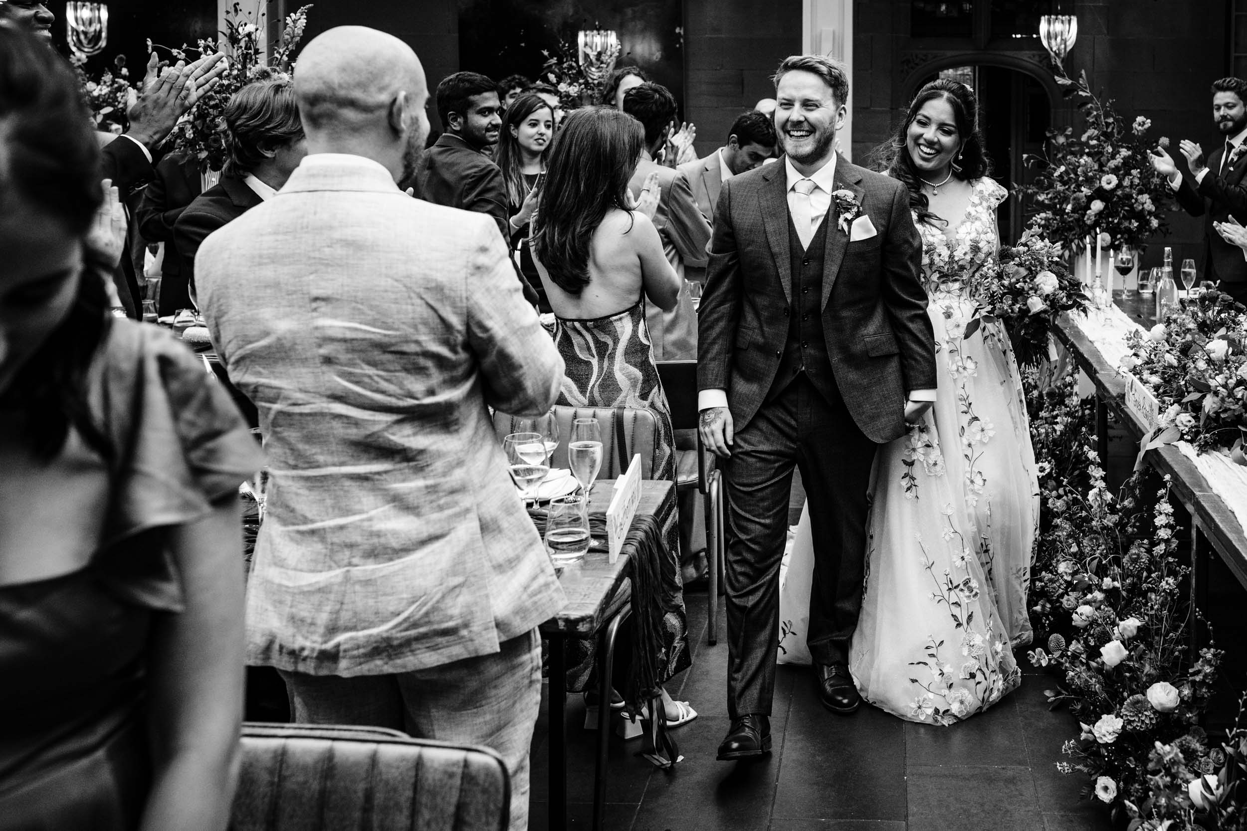 Anika and Sam entering the Hampton Manor dining room to cheers and applause