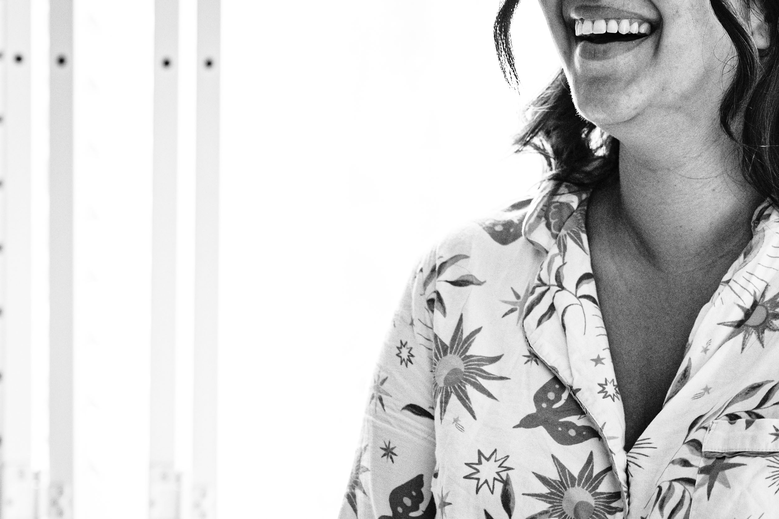 Bridesmaid laughing during morning prep at Hampton Manor