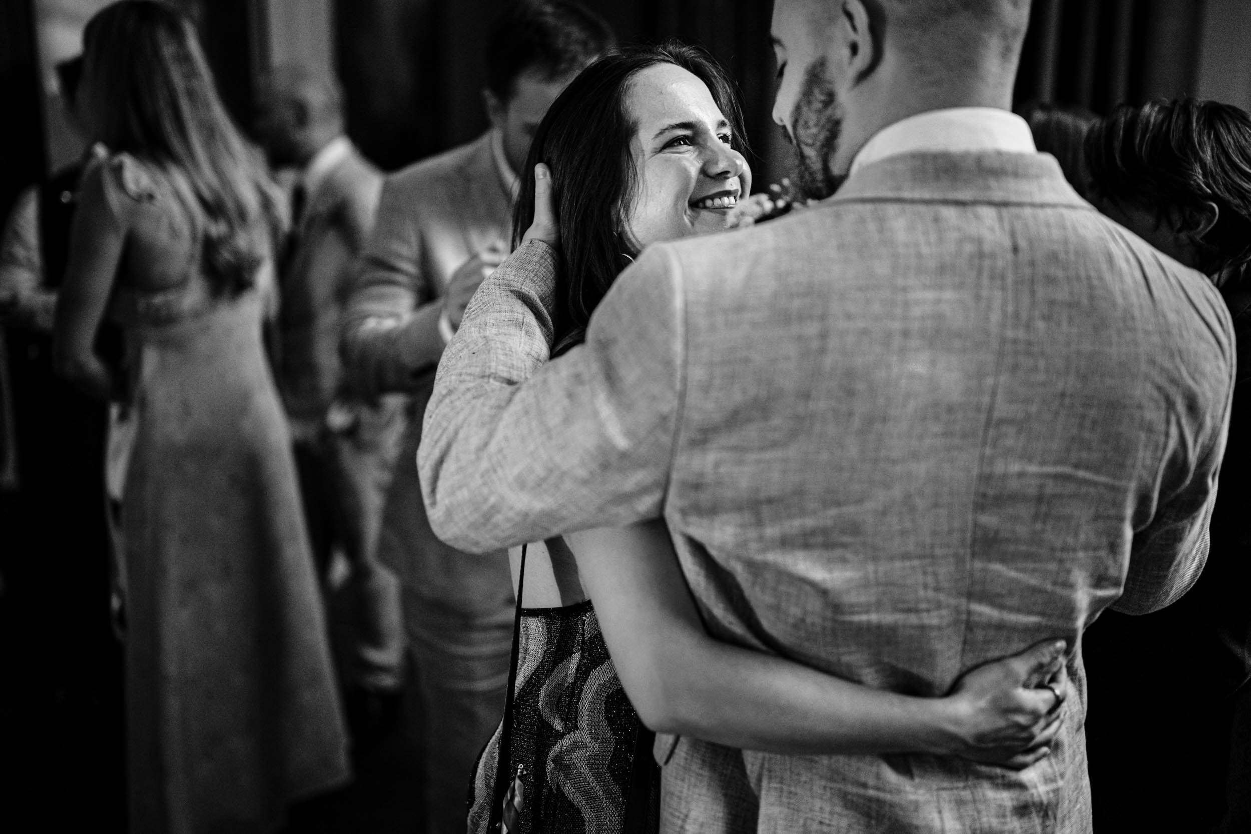 Guests hugging warmly during the evening reception