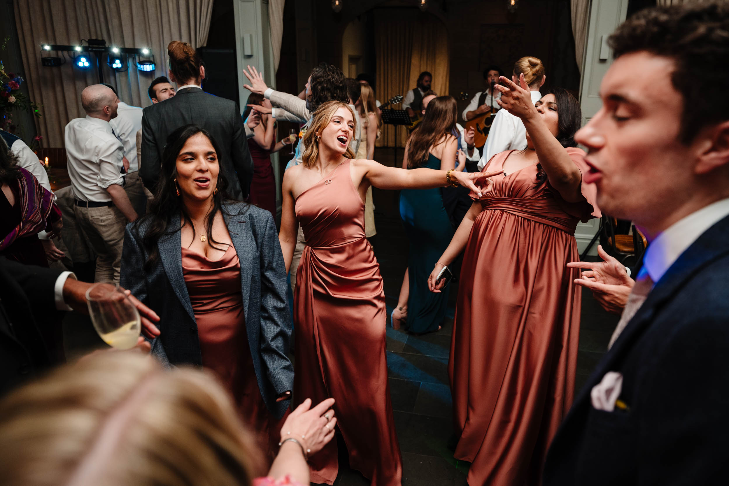 Bridesmaids dancing together during the evening party