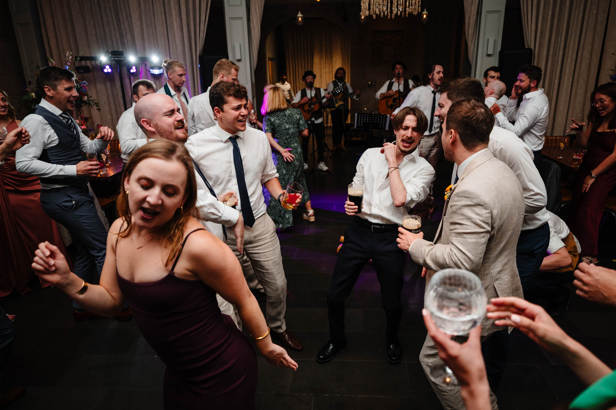 Energetic dancefloor moment with guests celebrating