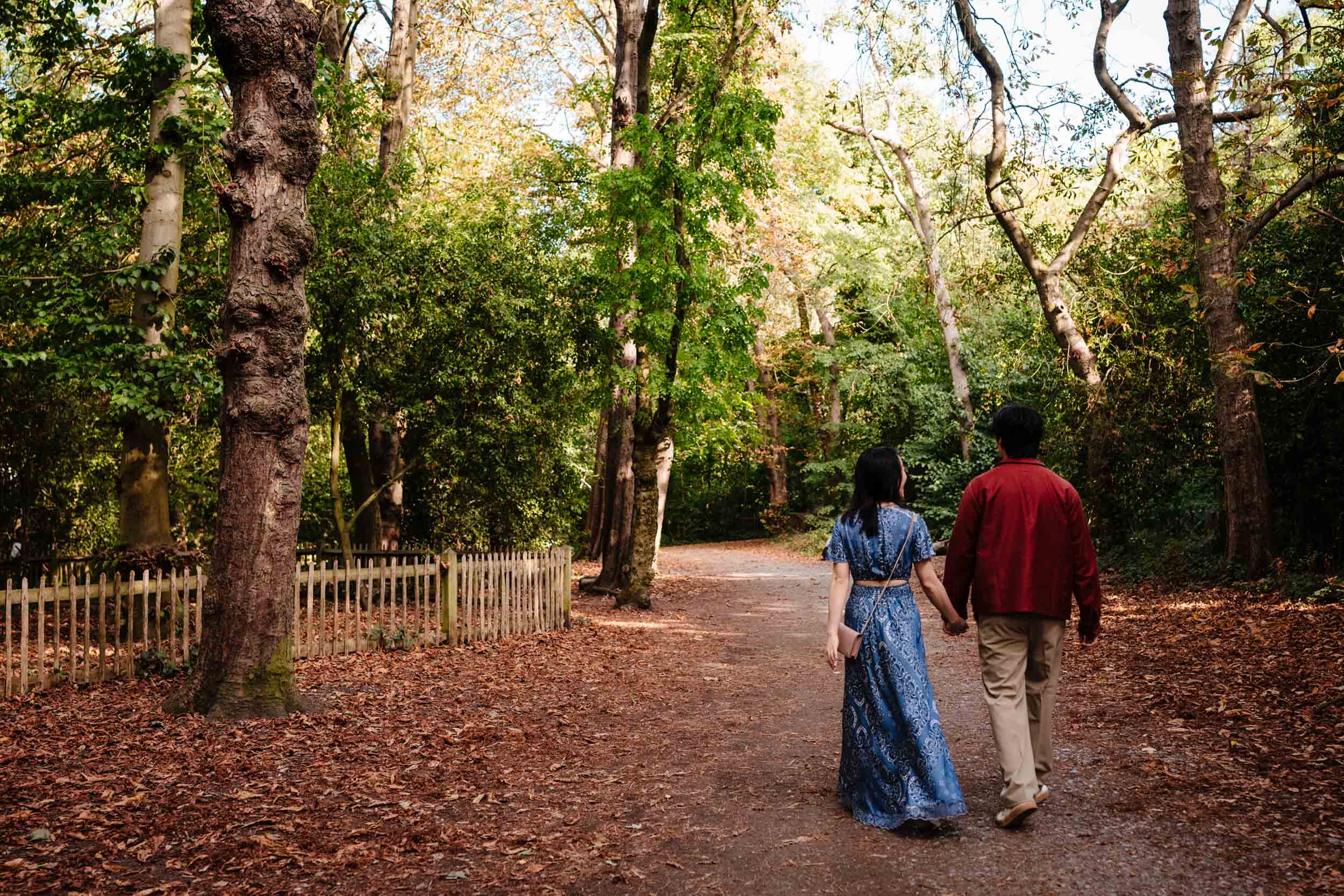 Couple walking hand in hand through Kyoto Garden after their proposal