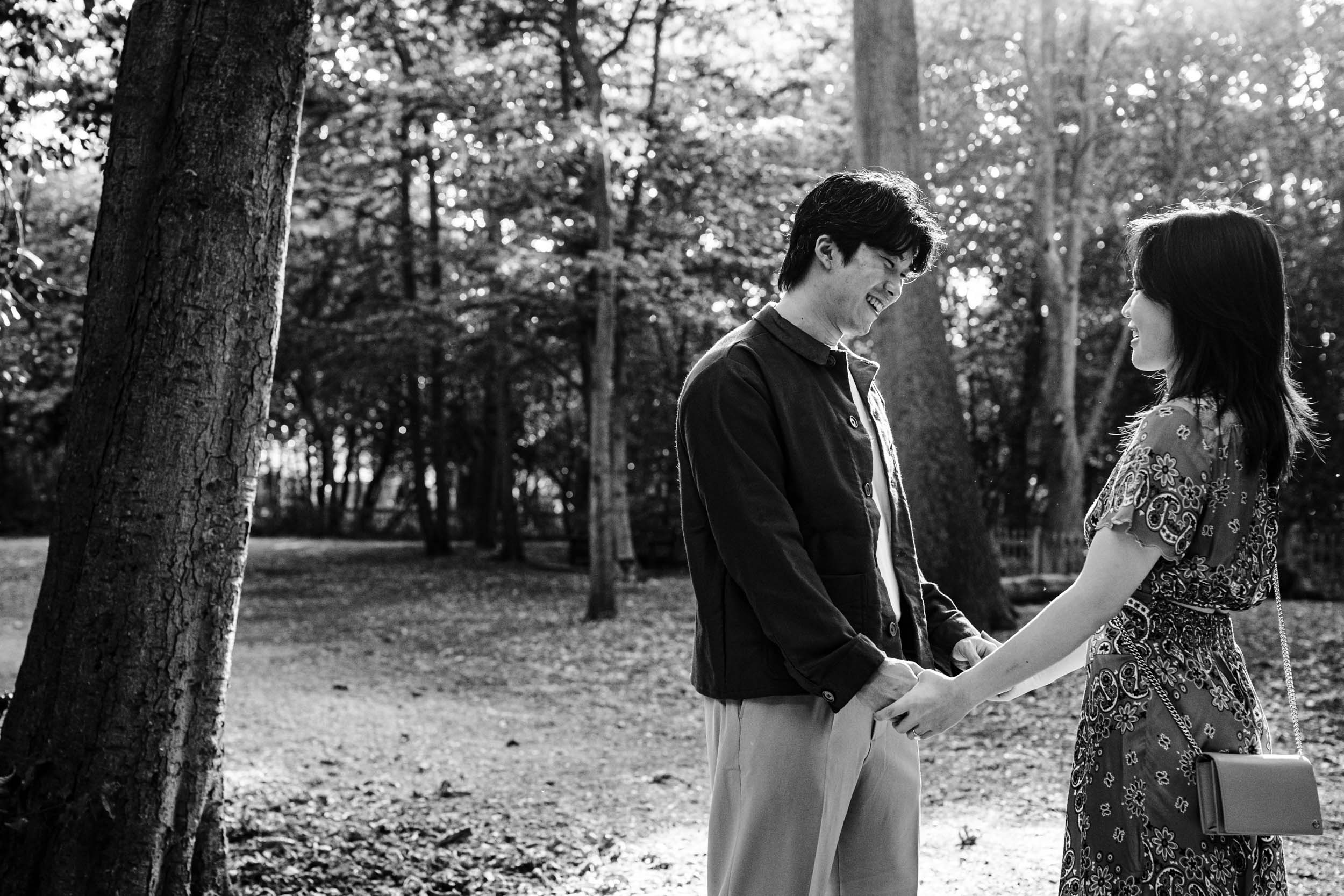 Jonas and Ariel holding hands and smiling at each other in Kyoto Garden