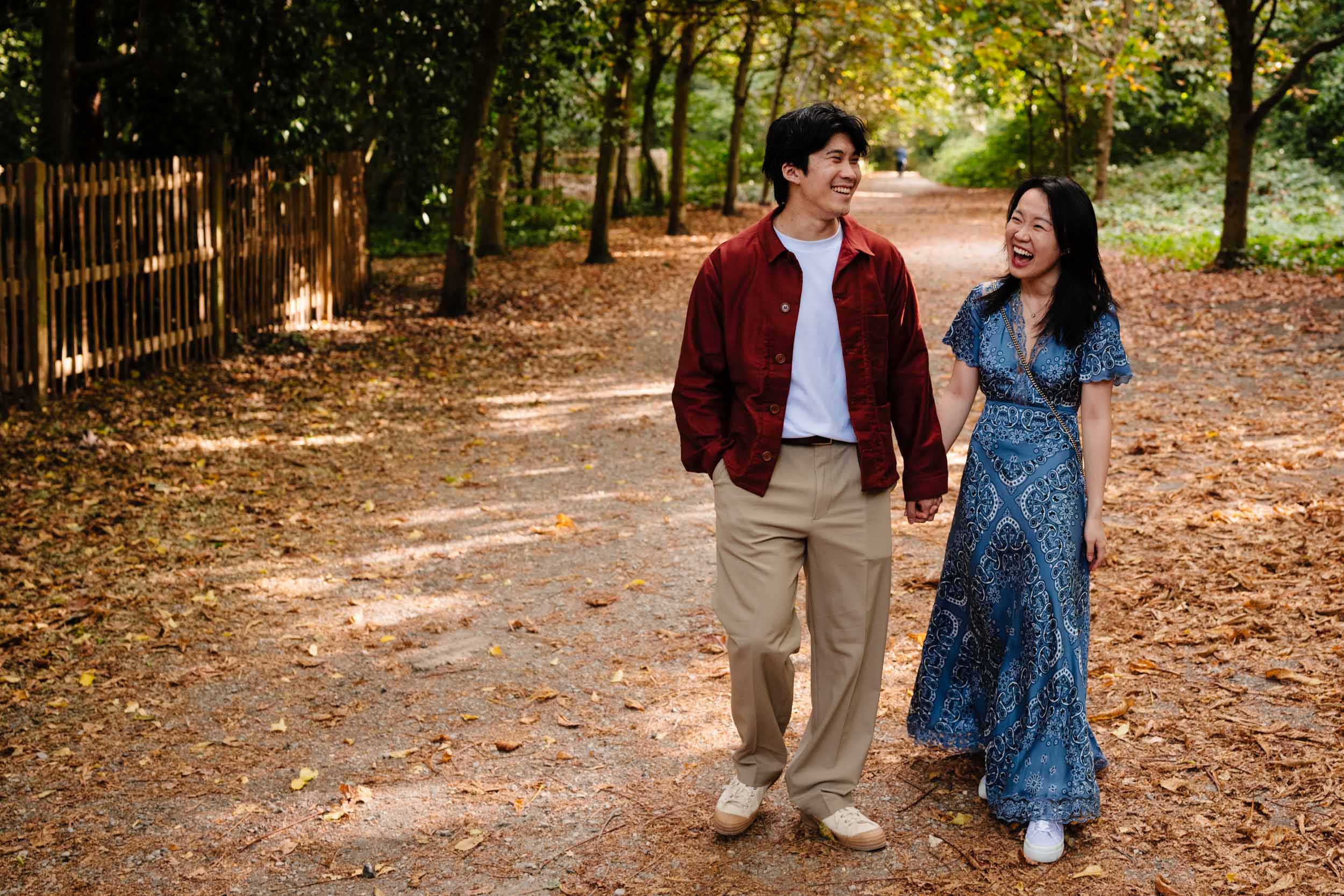Playful photo of the couple laughing while walking towards the camera in Kyoto Garden
