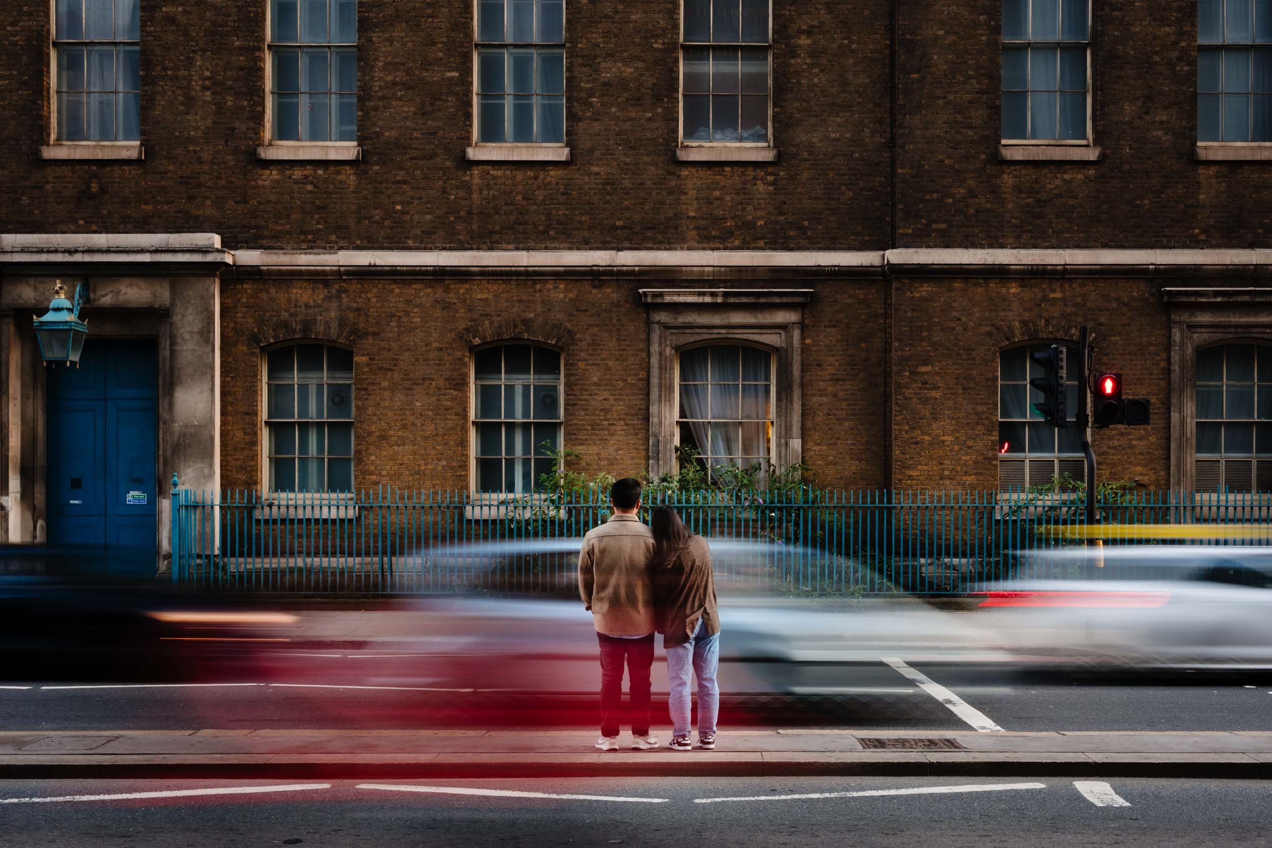 Couple waiting to cross the road towards Tower Bridge area after they got engaged