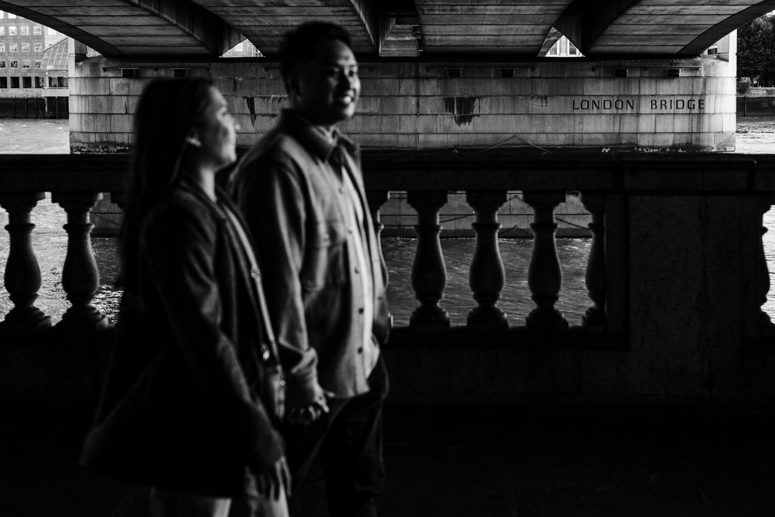 Candid moment under the London skyline after engagement