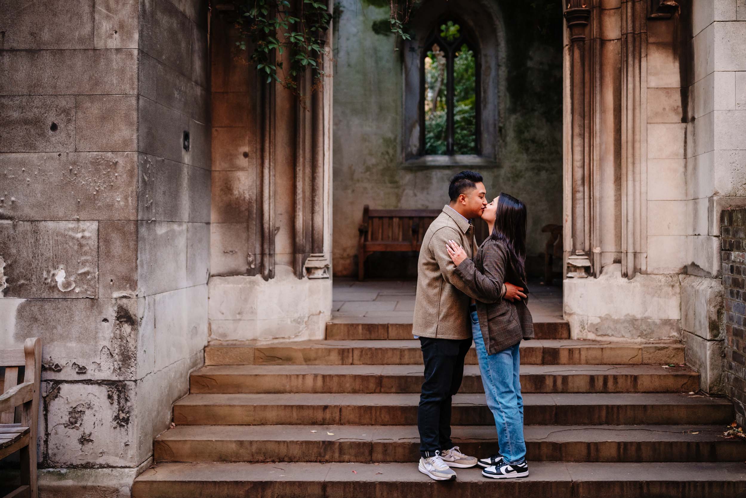 Documentary-style engagement photo at St Dunstan in the East