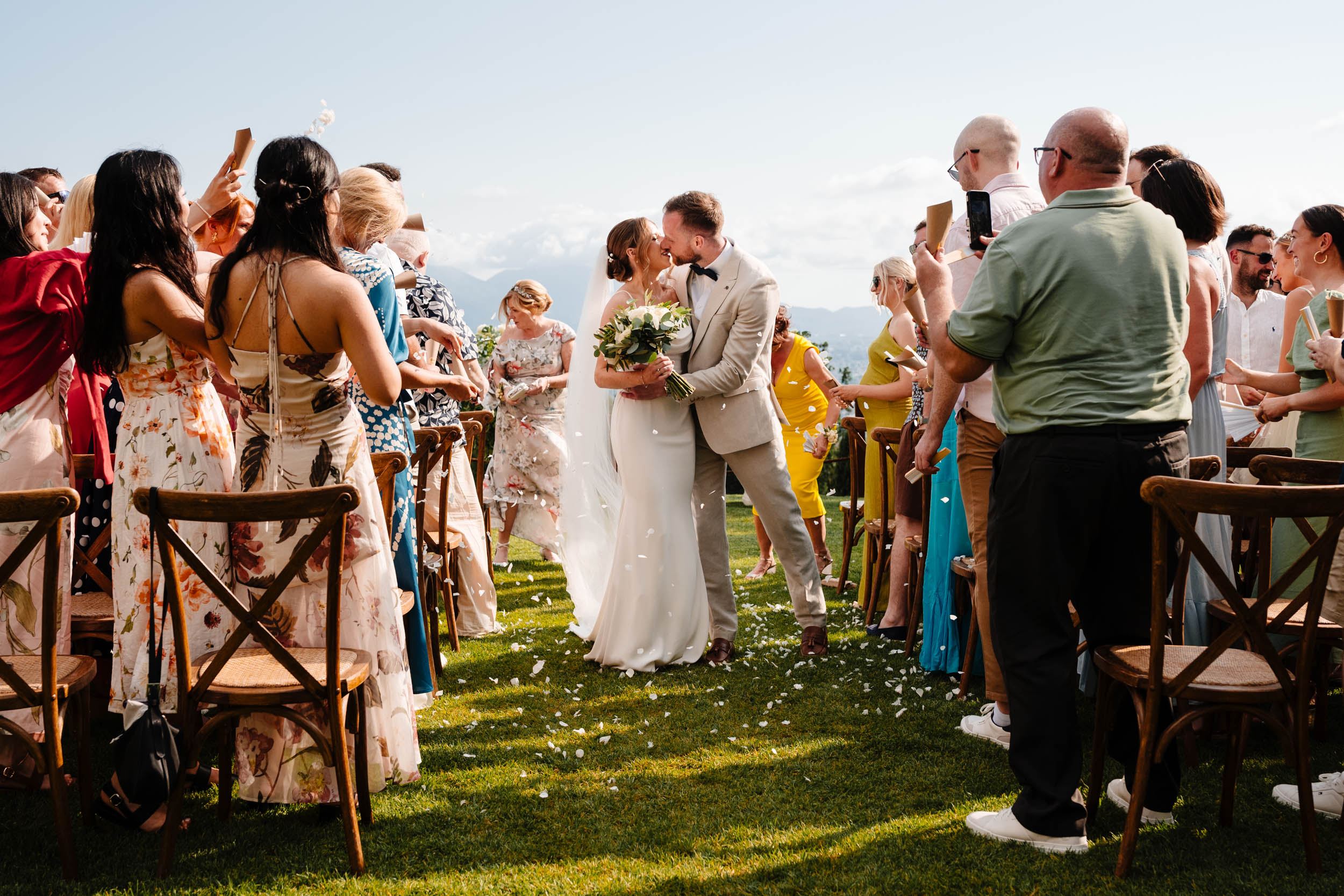 Bride and groom kissing during their confetti exit at Casale de Pasquinelli.