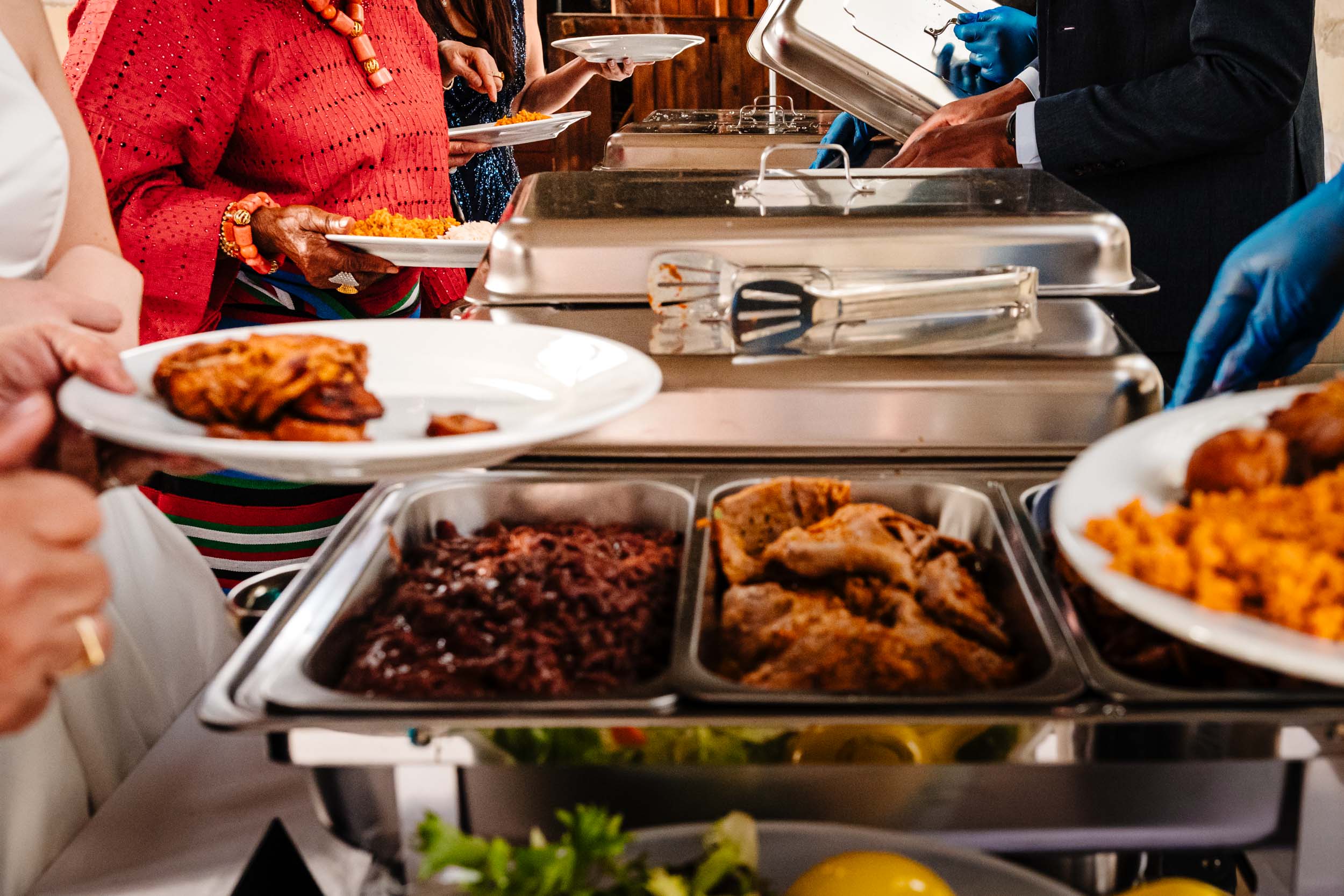 Guests helping themselves to food at the buffet during the wedding reception.