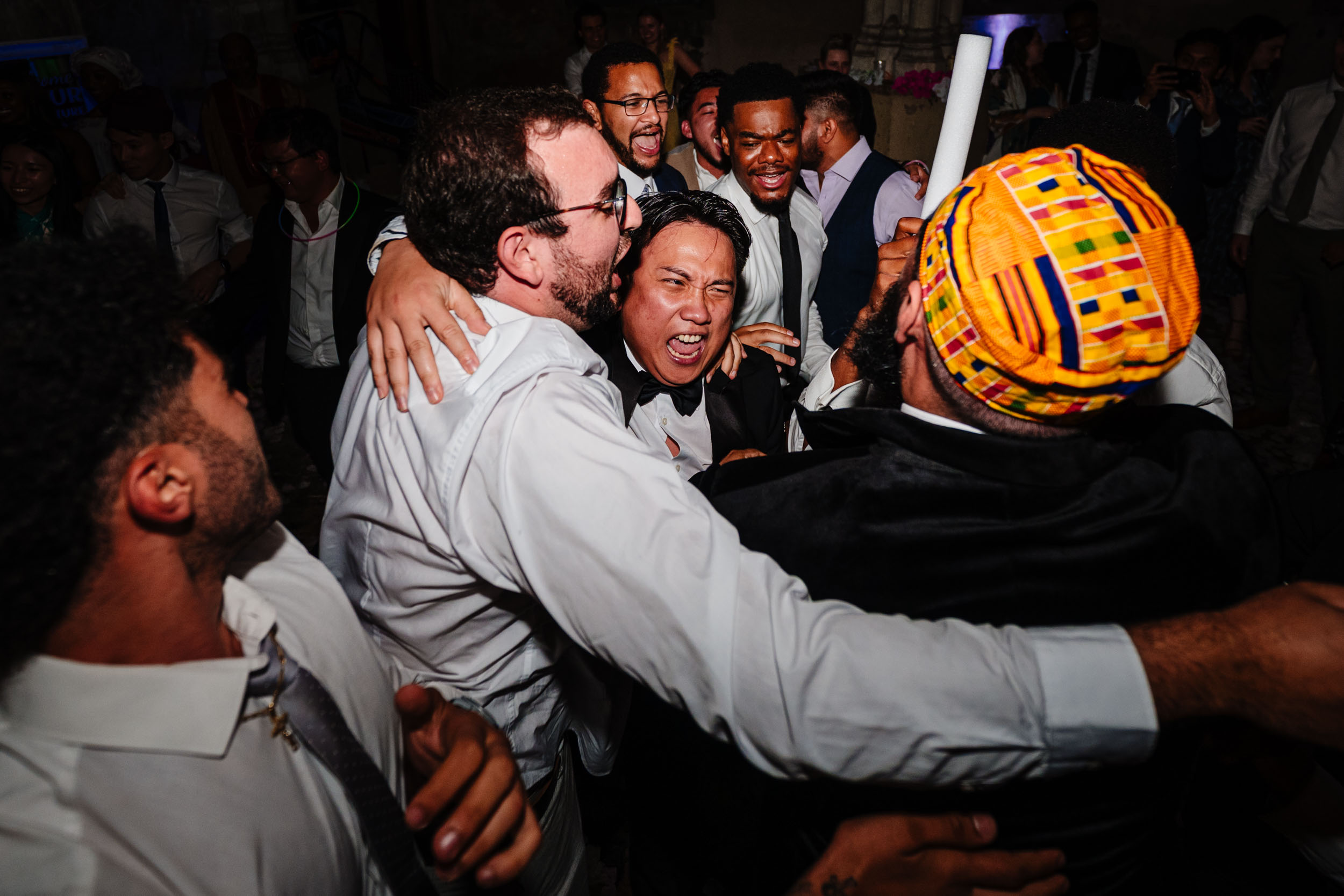Wedding guests dancing and having fun on the dance floor during the evening.