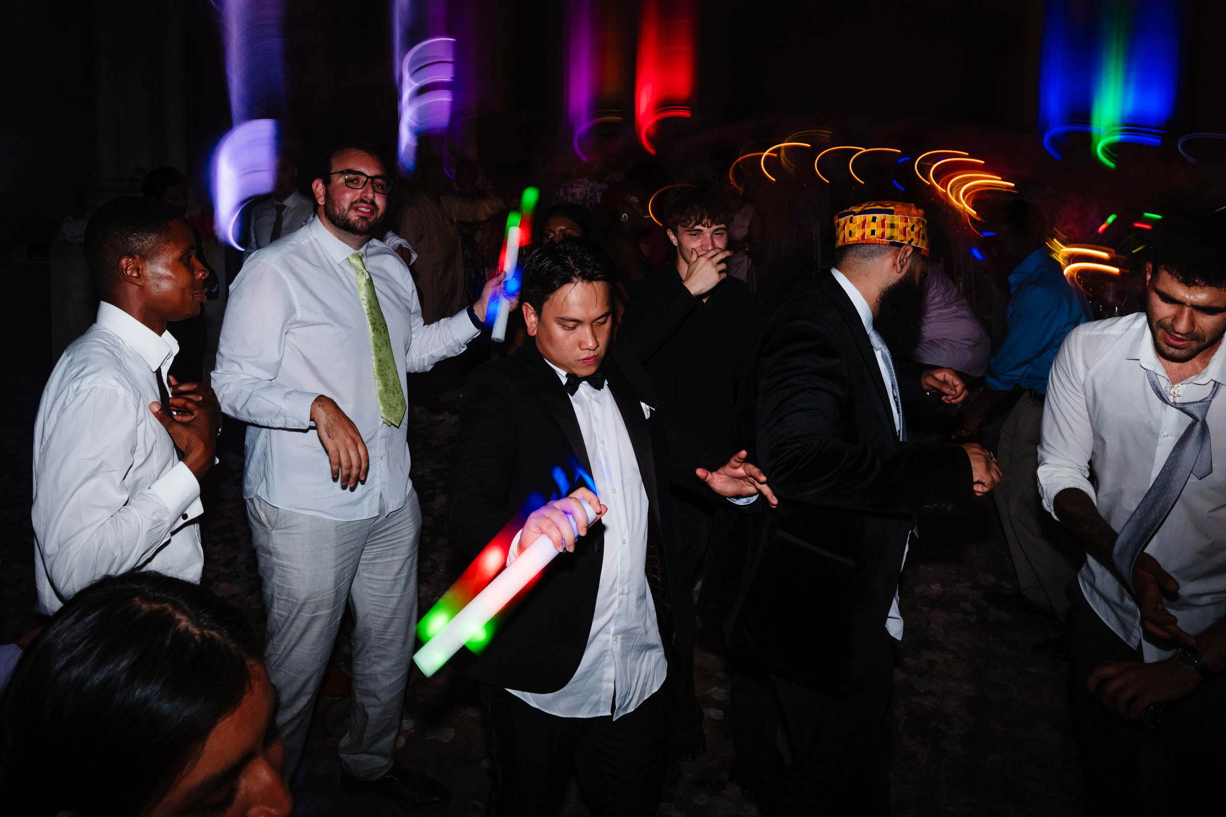 Shutter drag shot of guests dancing with motion and colour on the HAC Bow dance floor.