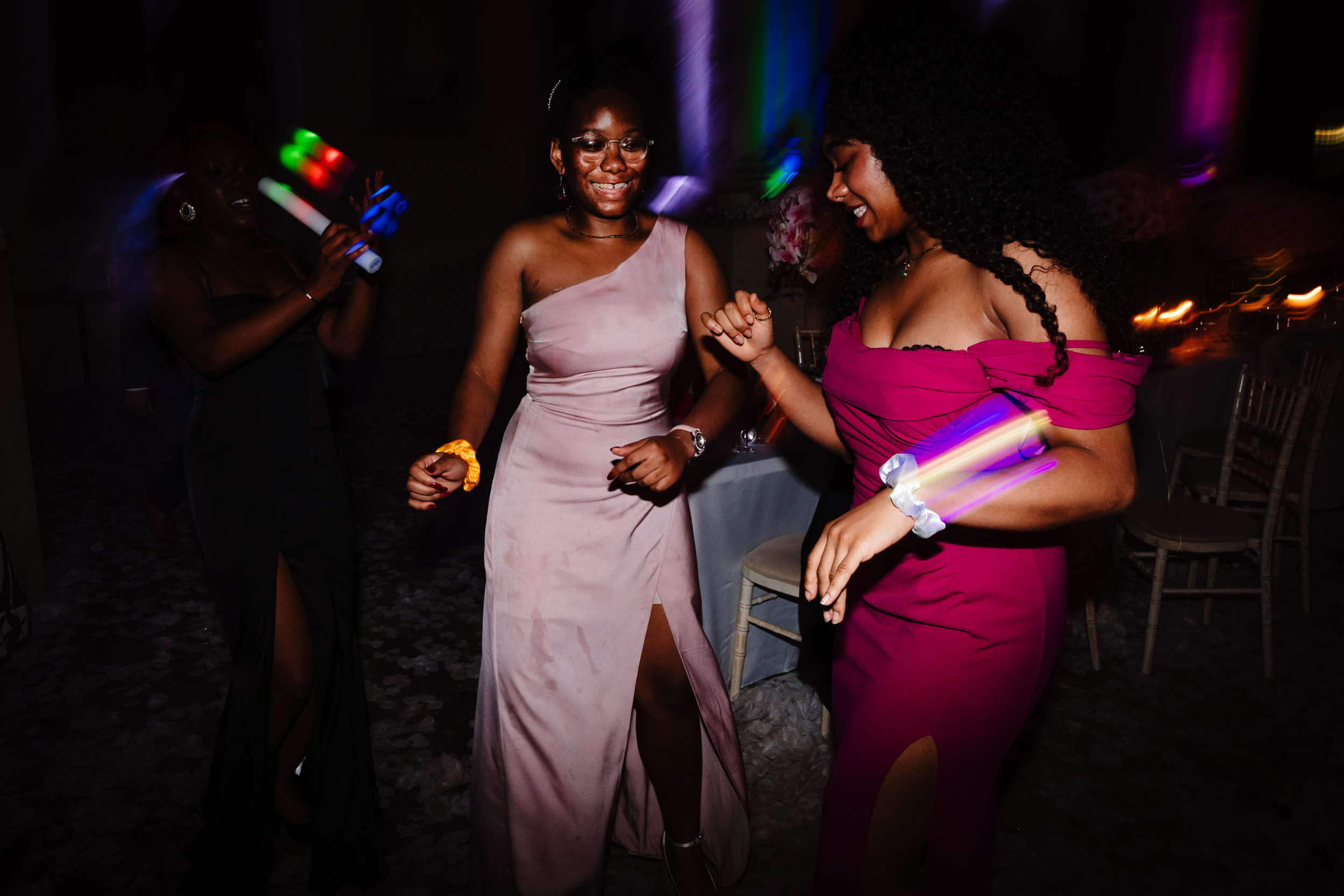 Joe’s sisters laughing and dancing together during the wedding reception.