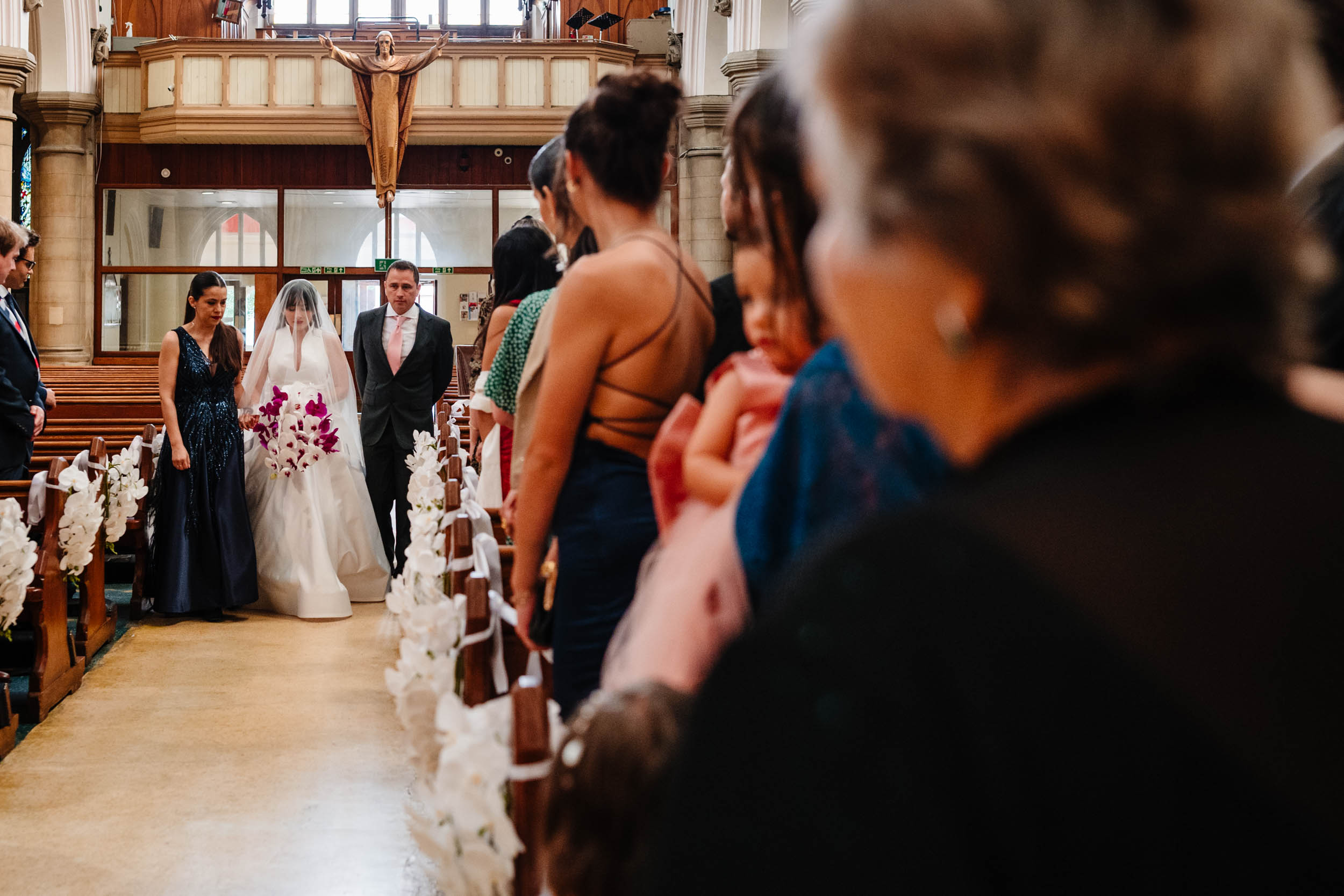 Sylvia walking down the aisle during the wedding ceremony at St Anthony of Padua.