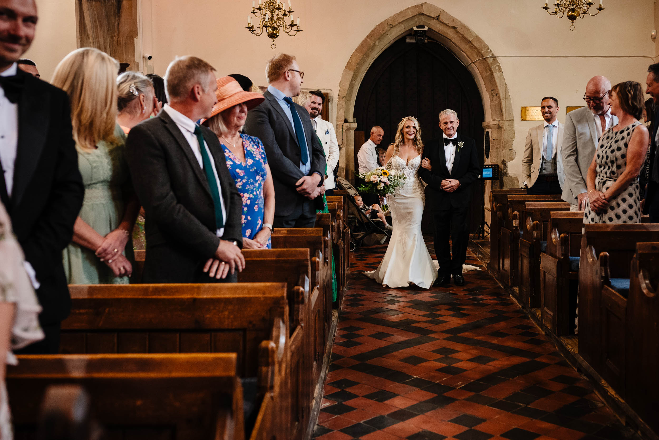 Bride walking down the aisle arm in arm with her dad
