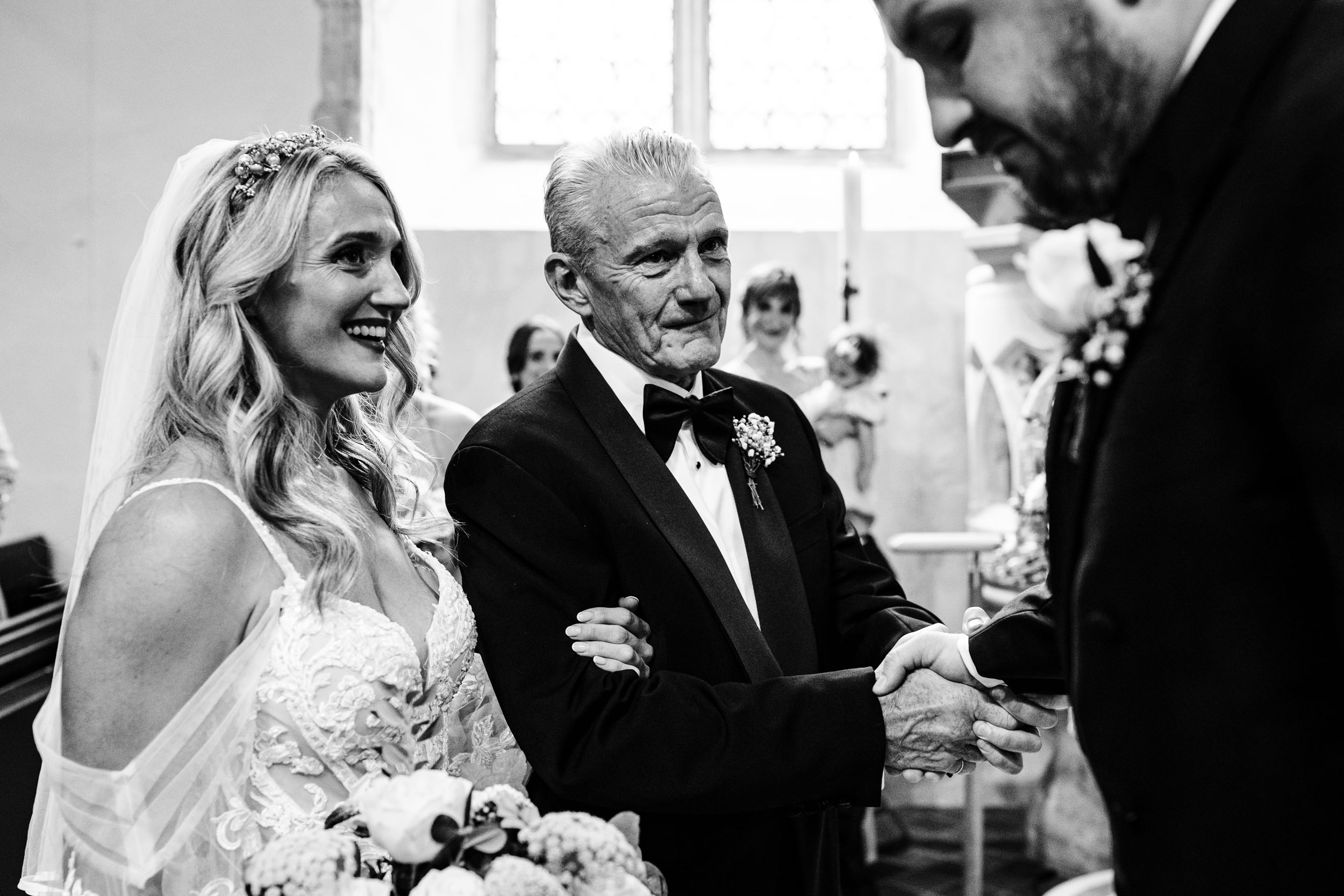 Groom shaking the bride’s dad’s hand at the altar
