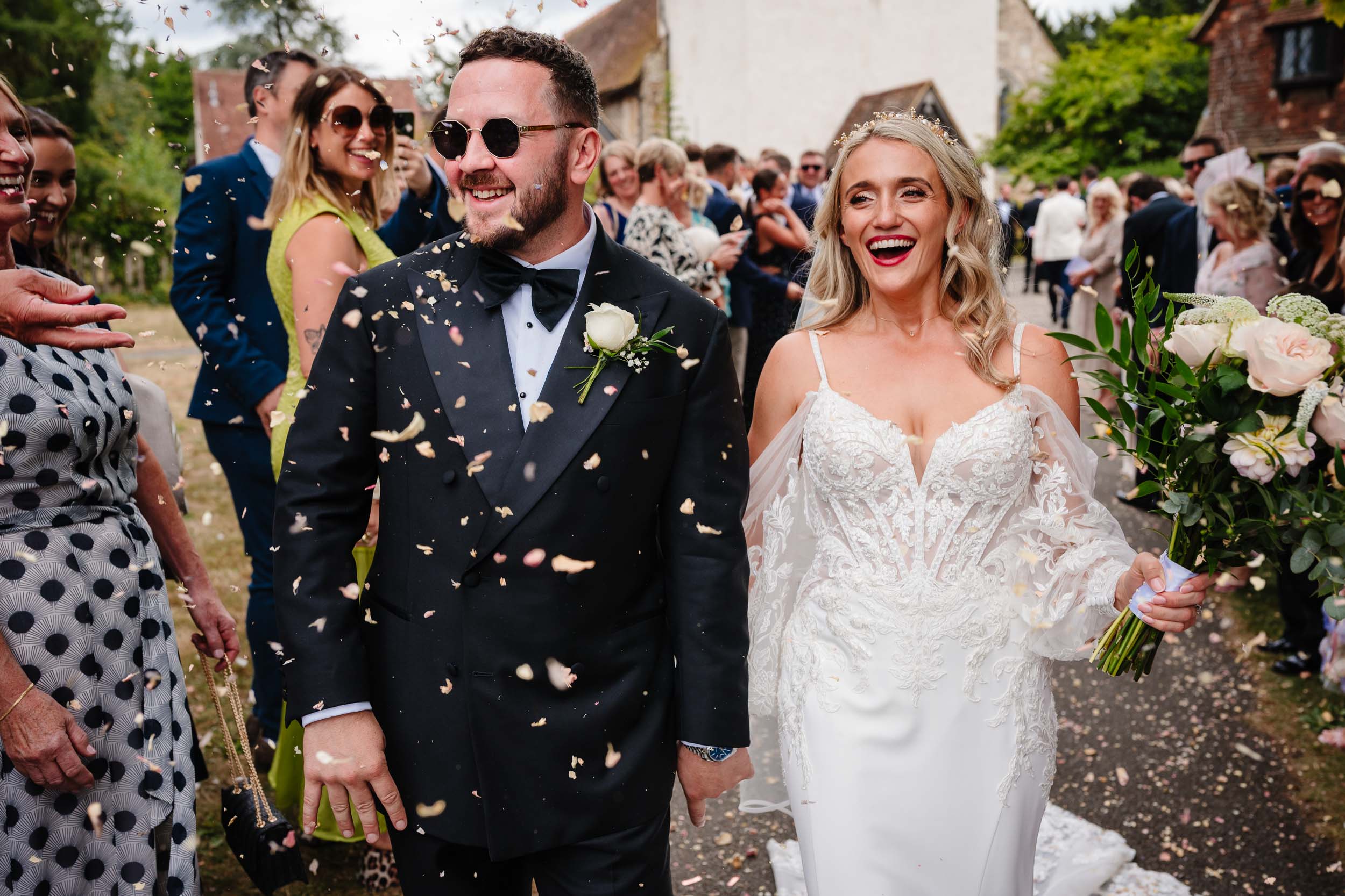 Bride and groom being showered with confetti outside the church