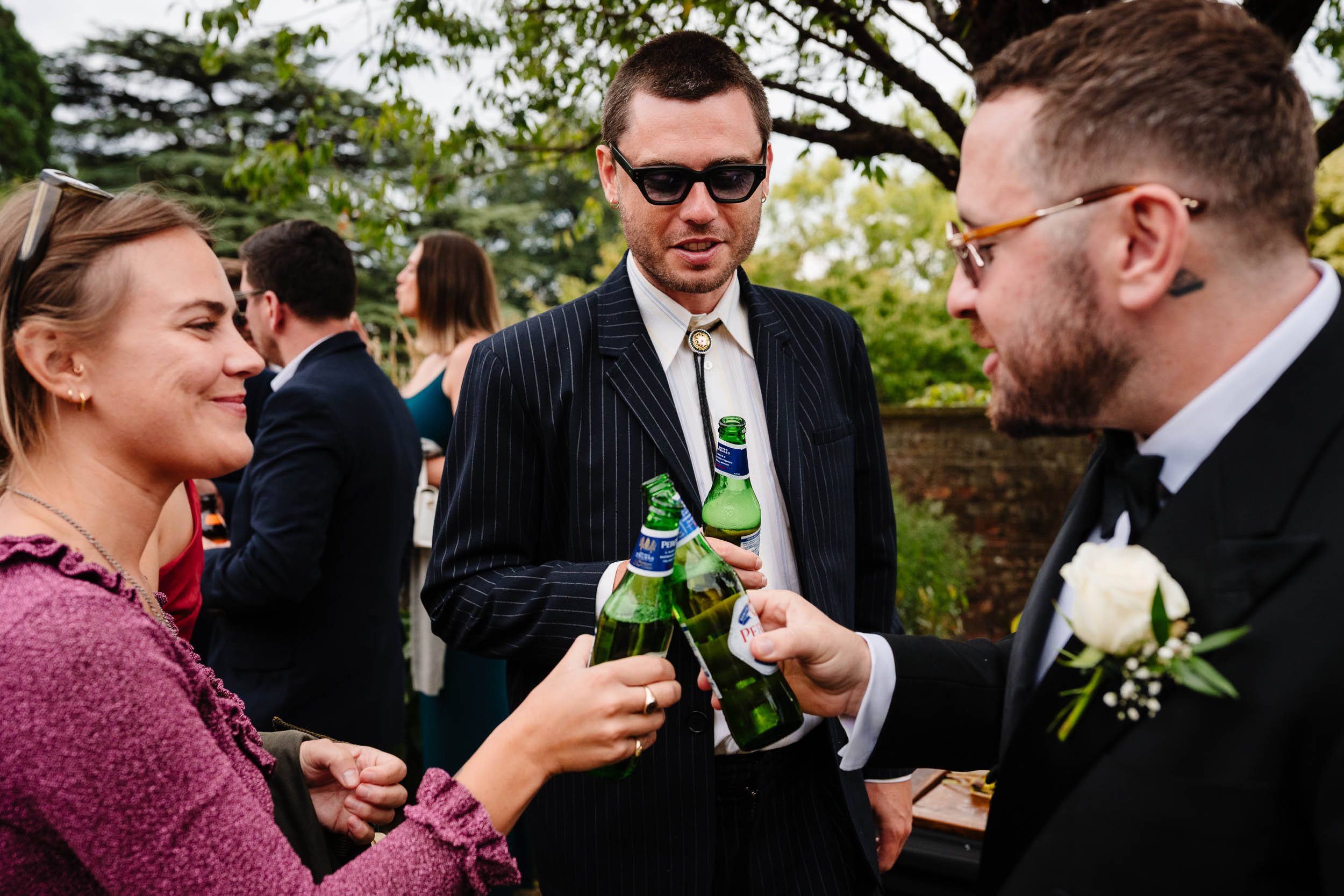 Wedding guests cheering and celebrating with the groom