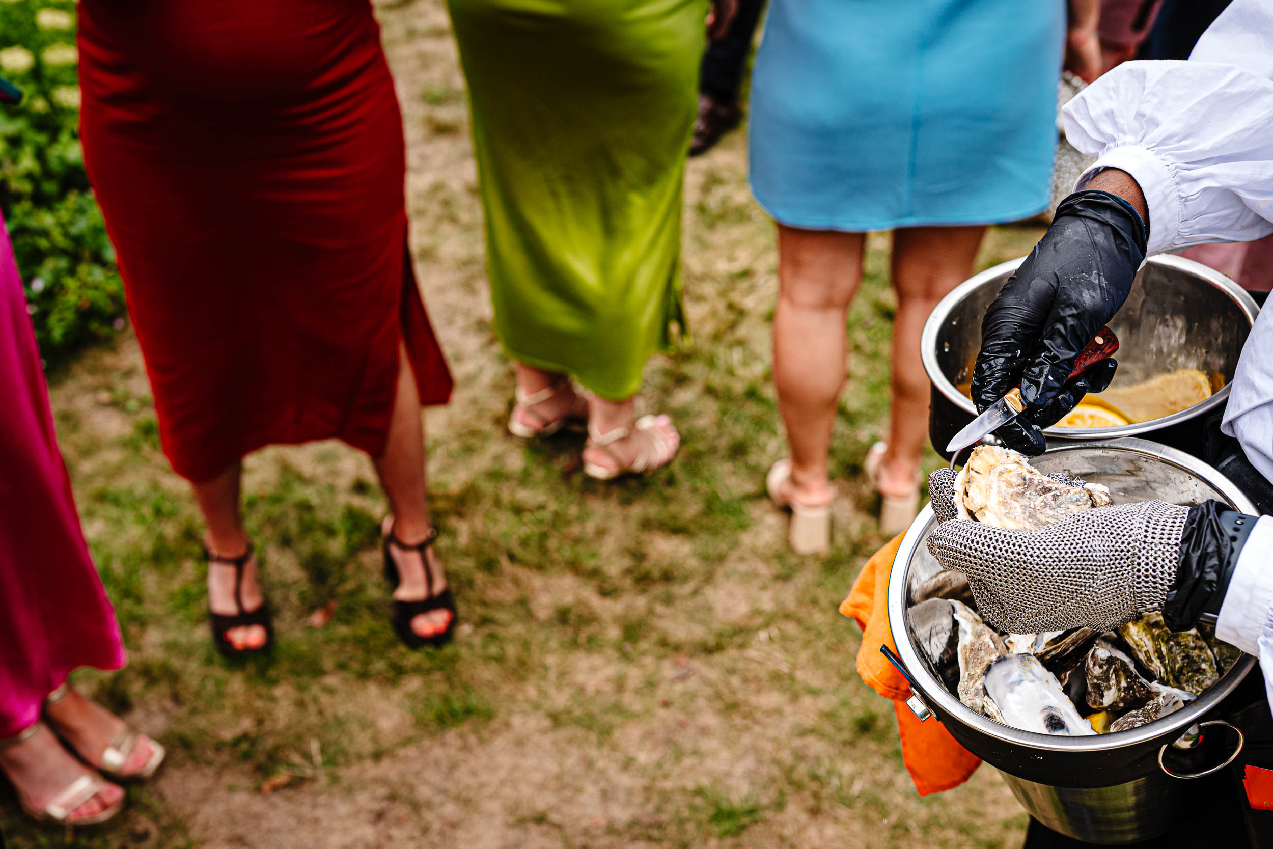 Colourful dresses and an oyster shucker preparing fresh oysters