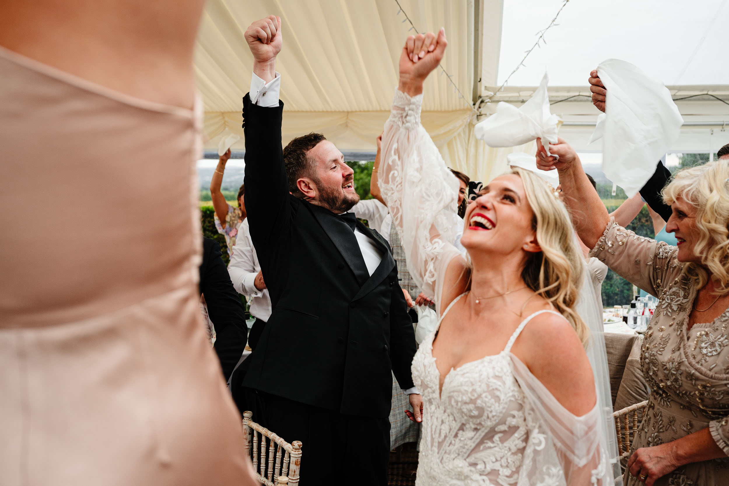 Bride and groom making a high energy entrance into the dining area