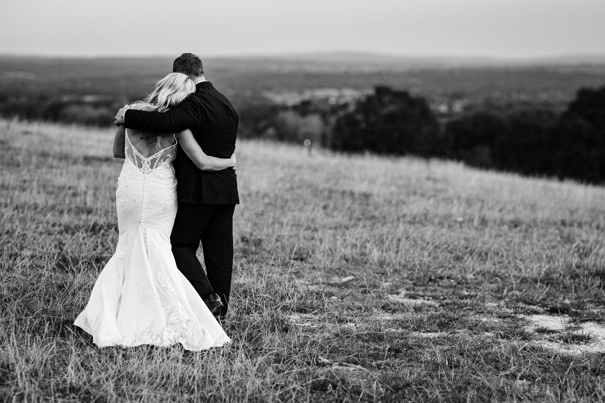 Bride and groom walking together on top of the hill for couple portraits