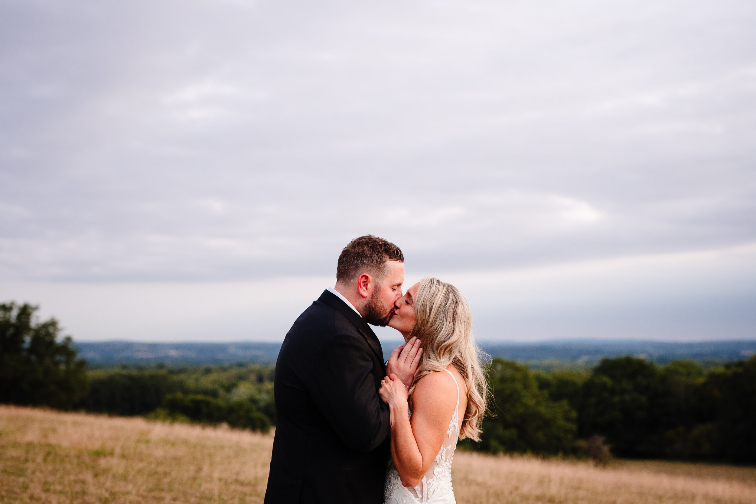 Bride and groom sharing a kiss during couple portraits