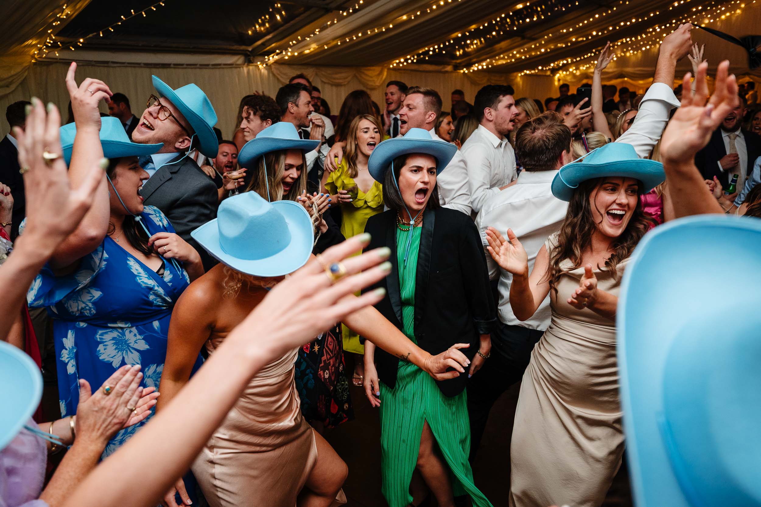 Wedding guests partying with blue hats on
