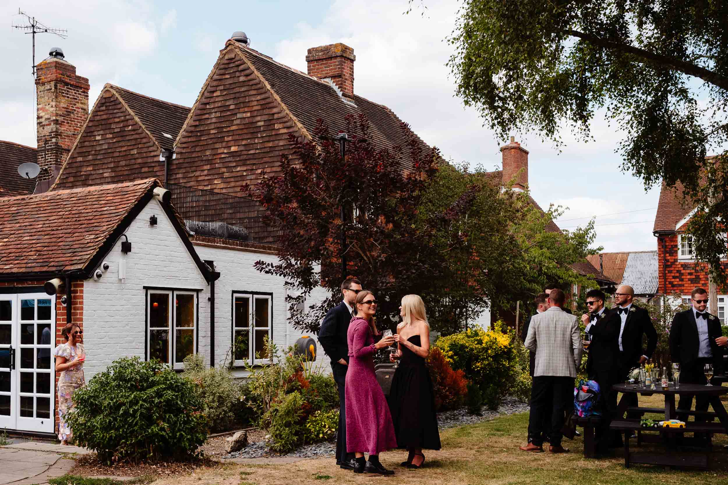 Wedding guests mingling and chatting at the pub