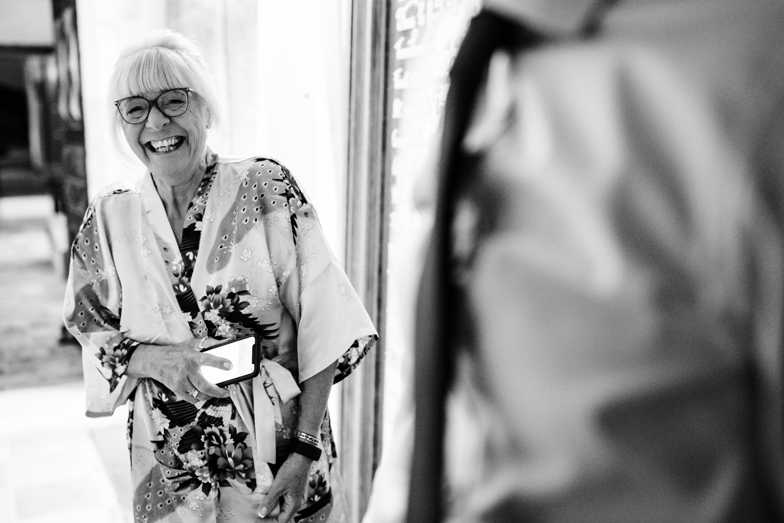 Best man’s mum laughing with the groomsmen while they get ready